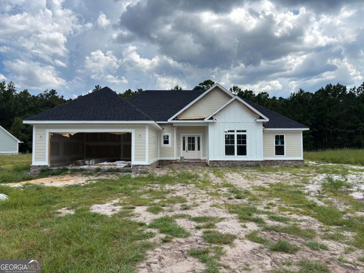 Welcome to this stunning brand-new construction located in the desirable River Oaks community. This 4-bedroom, 2-bath home sits on a generous 0.72-acre lot and offers thoughtful design and quality finishes throughout. A charming front porch leads into the foyer and spacious living room, all featuring durable and stylish LVP flooring. The modern kitchen is equipped with stainless steel appliances and includes a pantry with built-in wooden shelving. Adjacent to the kitchen are a convenient mudroom and laundry room. The primary suite is a true retreat with trayed ceilings, a luxurious en suite bathroom featuring double vanities, a separate tiled shower, a soaking tub, and a walk-in closet with custom wooden shelving. Three additional guest bedrooms provide plenty of additional space. A rear porch offers the perfect spot for outdoor relaxation, and a two-car garage adds functionality to this beautifully designed home. Estimated completion date Sept. 2025