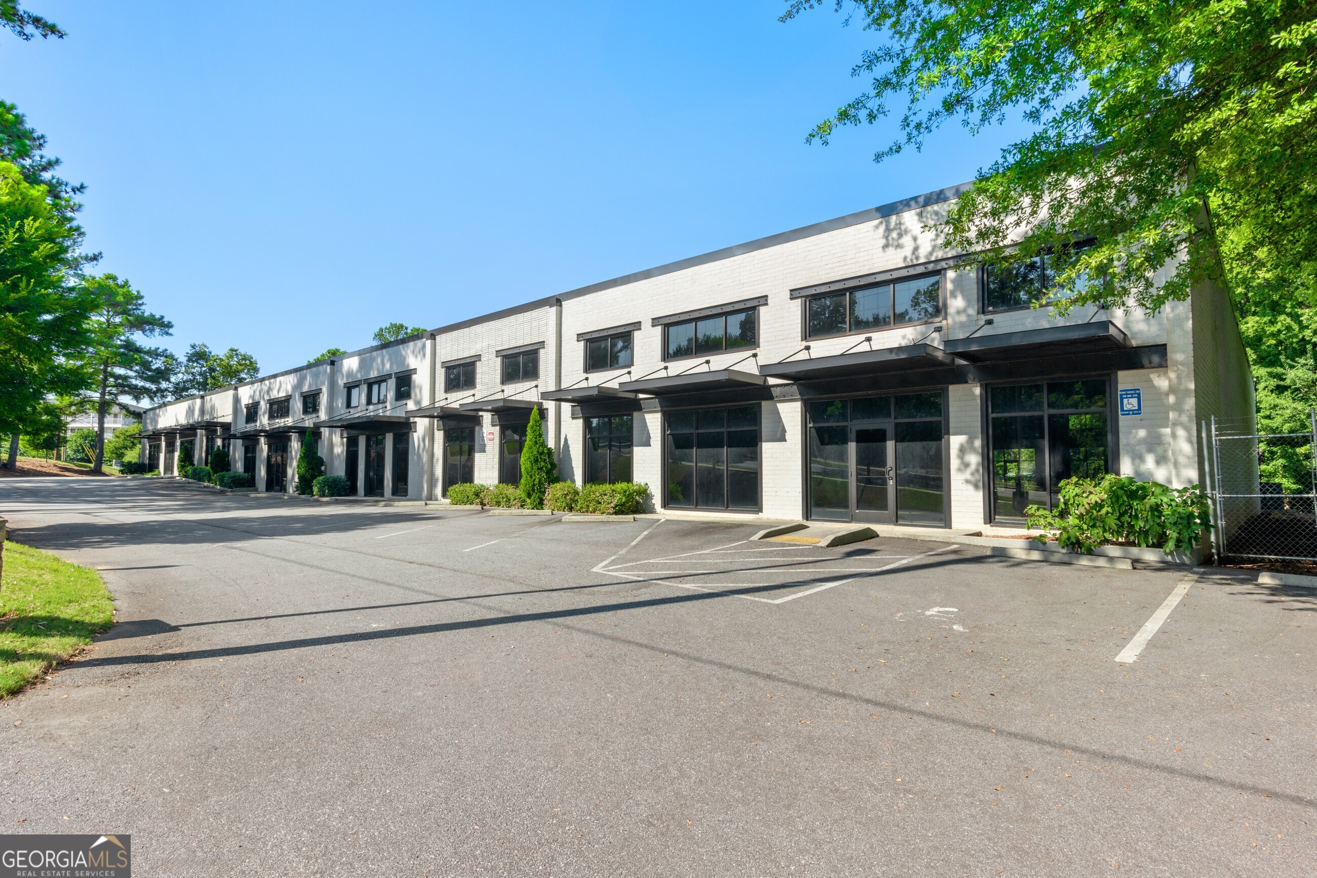 This amazing Industrial/Flex building, located in a prime area of Atlanta, offers exceptional flexibility and over $1 million in recent capital improvements. Currently divided into four suites, the property can easily be reconfigured into a larger open space or subdivided into up to eight separate units. Notable upgrades include a new TPO membrane roof with metal decking, 12 new Trane HVAC units, and fresh exterior paint. With over 80 parking spaces, including ADA-compliant parking, and access from both the front and rear of the property, this building is well-equipped to accommodate a variety of business needs.  The location is unbeatable, with close proximity to Peachtree Industrial Blvd, I-285, and just two blocks from Chamblee Village. It's also conveniently located two miles from Peachtree-DeKalb Airport and only one mile from the Chamblee MARTA station, ensuring easy access for employees and clients. Whether you're looking for a new headquarters, expanding your operations, or investing in a highly versatile property, this space offers a unique opportunity in one of Atlanta's most strategic commercial areas.