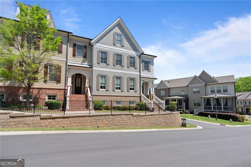 A Townhome You'll Love to Call Home - End Unit on a Corner Lot with Three-Car Garage! Discover the perfect blend of comfort, elegance, and convenience in this beautifully appointed end-unit townhome, ideally situated on a desirable corner lot with an unfinished basement ready for your personal touch. Located in the up-and-coming city of Canton, this home combines small-town charm with modern amenities including a community clubhouse and pool just in time for summer fun! From the moment you arrive, the curb appeal is undeniable with cedar shaker accents, brick-lined exterior, and a covered front porch. Inside, you're greeted by hardwood floors, elegant trim work, and a flowing open-concept layout that balances style with functionality. The formal dining room feels bright and expansive, framed by arched entryways that create a seamless flow for mingling no matter the occasion. Cozy up in the family room, which features a classic stacked stone fireplace flanked by custom built-ins. The eat-in kitchen is complete with an island, breakfast bar, stainless steel appliances, granite counter tops, gas cooktop, wall oven, and a lovely travertine backsplash. Step outside to your covered balcony, perfect for relaxing evenings with a ceiling fan, recessed lighting, and partitioned privacy for added comfort. Upstairs, the primary suite features tray ceilings, a huge double vanity, walk-in shower, and a soaking tub to unwind at the end of the day. Two spacious secondary bedrooms, one of which offers en-suite bathroom access, provide plenty of room to meet your needs. A laundry room upstairs adds everyday convenience. With a rare three-car garage, tons of curb appeal, and a location near some of Canton's best local restaurants and shops, this home has it all in a quiet, welcoming community you'll be proud to call your own.