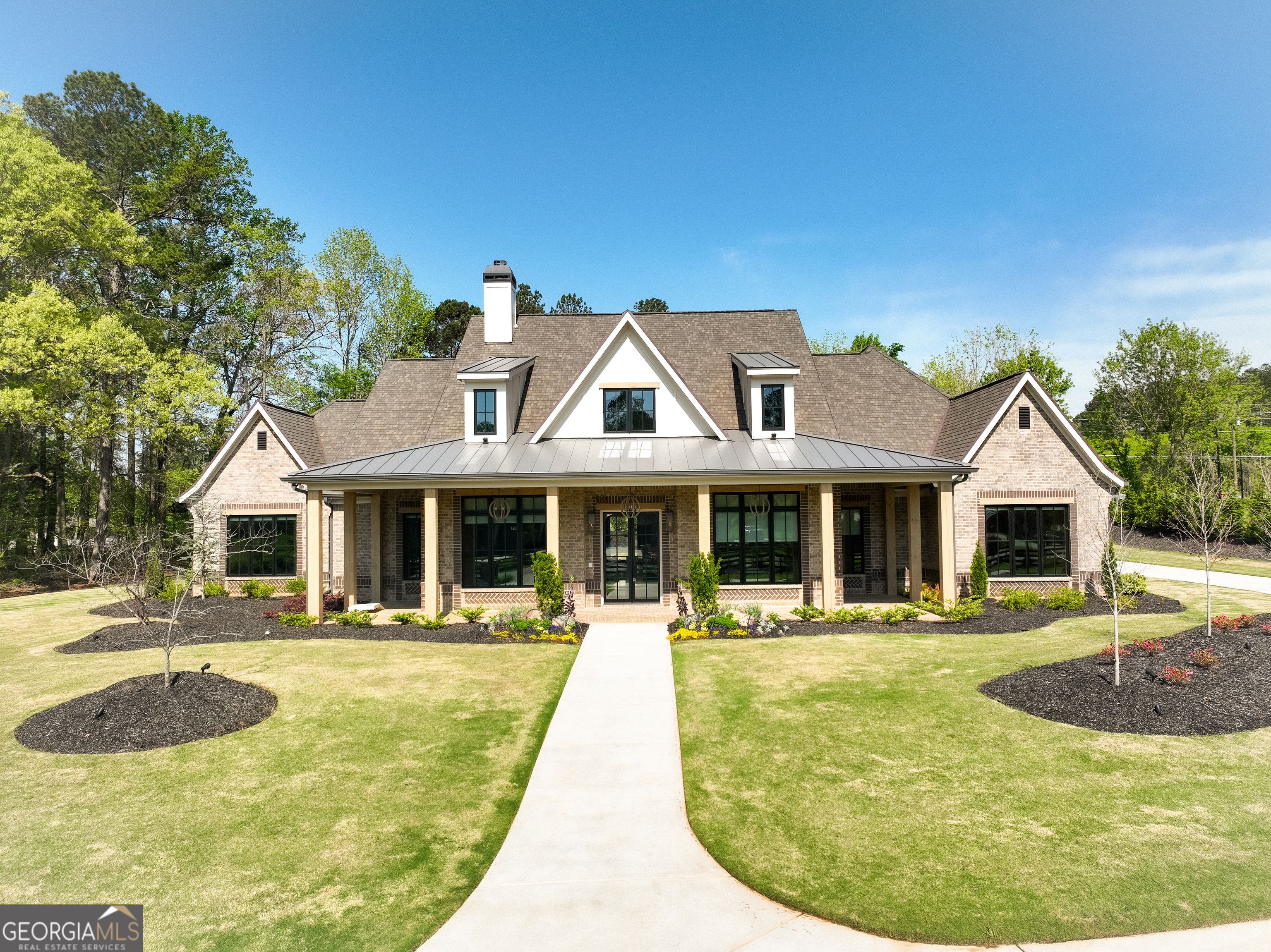 Welcome to your dream home! As you enter the driveway, you are greeted by two elegant columns adorned with beautiful gas lanterns, setting the tone for the charm and sophistication that awaits. Meticulously designed and built with the highest quality materials and cutting edge technology, this home is the epitome of modern luxury and durability. Every detail of this brand New Construction Home has been thoughtfully curated ensuring a unique and luxurious living experience. From the custom built details to the high end finishes. This Craftsman-style home offers luxury living in Alpharetta's sought-after Cherokee County. No detail has been overlooked! Boasting exquisite brick construction this home exudes elegance and charm. Nestled in Alpharetta, Georgia, this property offers the perfect blend of suburban tranquility and urban convenience. Enjoy easy access to top-rated schools (Avery, Creekland, Creekview and The Haven Academy), parks, shopping centers, and dining options. Experience culinary excellence with top-of-the-line appliances. Elevate your living space with locally crafted custom cabinets. Enjoy the timeless beauty and durability of stain in place hardwood flooring throughout the home. Our properties feature exquisite high performance concrete countertops with built-in sinks. Entertain in style with a fully equipped outdoor kitchen featuring Wolf and Sub Zero appliances. Relax in the shade of your 1000CO square foot covered patio, adorned with elegant herringbone solid brick detailing. Built in heaters on the patio will keep you cozy on those chilly nights. Prepare to be amazed by the meticulously designed master closet, perfect for that discerning client. Enjoy the luxury of heated Master Bathroom tile floors. From intricate trim work to designer fixtures, this home is filled with upscale details that set it apart from the rest. Prewired EV garage outlet. Control your HVAC, Lights, Surround Sound, and Lutron Window Shades effortlessly from your smartphone. Our roofing materials are made with F Wave premium synthetic roof shingles and offer a lifetime warranty. They are made to with withstand 130 mph winds, Class 4 Hail, and Class A fire protection. Our Casement windows are backed with a 10 year warranty (20 year glass warranty). With too many upgrades to mention, this home offers luxury living at its finest. In addition to the main living and bonus square footage, this home includes an additional 2411 square feet (front and rear porch plus garage) for a total of 6434 square feet (under roof and all other areas). Showings scheduled upon receipt of Proof of Funds (POF) or PreQual Letter. Listing agent will be present for all showings to provide intricate details of this exquisite property. This subdivision will have a total of 7 New Homes and is a Preplanned Community. Individual Lots are not for sale. Backyard is approved for an inground pool.