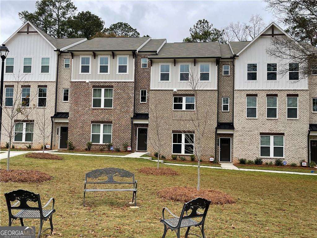 a stunning 3-bedroom, 3.5-bathroom townhome offering 2,400 square feet of thoughtfully designed living space in the heart of Decatur. Built in 2024, this contemporary residence blends upscale finishes with functional elegance across three spacious levels. Open-concept layout with dark wood flooring, recessed lighting, and abundant natural light. The gourmet kitchen featuring white cabinetry, herringbone tile backsplash, stainless steel appliances, and a marble island with built-in sink. The expansive living area with a sleek electric fireplace, ceiling fan, and direct access to a private outdoor space. The luxurious bathrooms with glass-enclosed showers, marble tile flooring, and modern vanities. The generous bedrooms with walk-in closets and en-suite baths for ultimate privacy and comfort