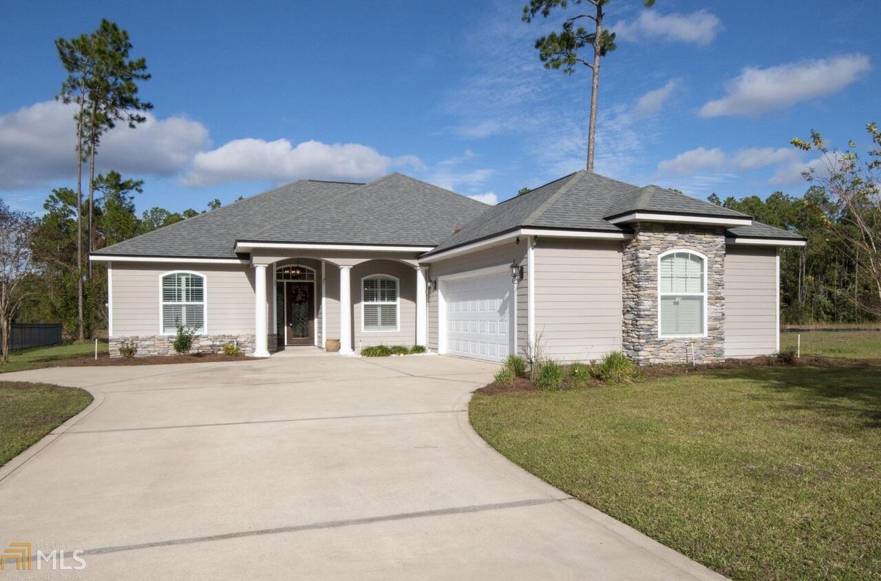 This home in move-in ready, offers an open concept floor plan and has gorgeous custom features throughout. Built by WH Gross, no detail was missed! With trey ceilings, crown moulding, blinds and plantation shutters, stainless steel appliances, granite counters and custom cabinetry in the kitchen - 123 Oarsman has all you need! From both the master bedroom and living room, access the screened-in lanai to enjoy a spacious lawn and peaceful lake view. This 4 bedroom, 2 1/2 bath home affords space for everyone and has TONS of storage! Located in Winding River, you'll love the quick route to Kings Bay Naval Base and I-95, this community offers a pool, Savannah Club and great social calendar. Call today to preview this home!
