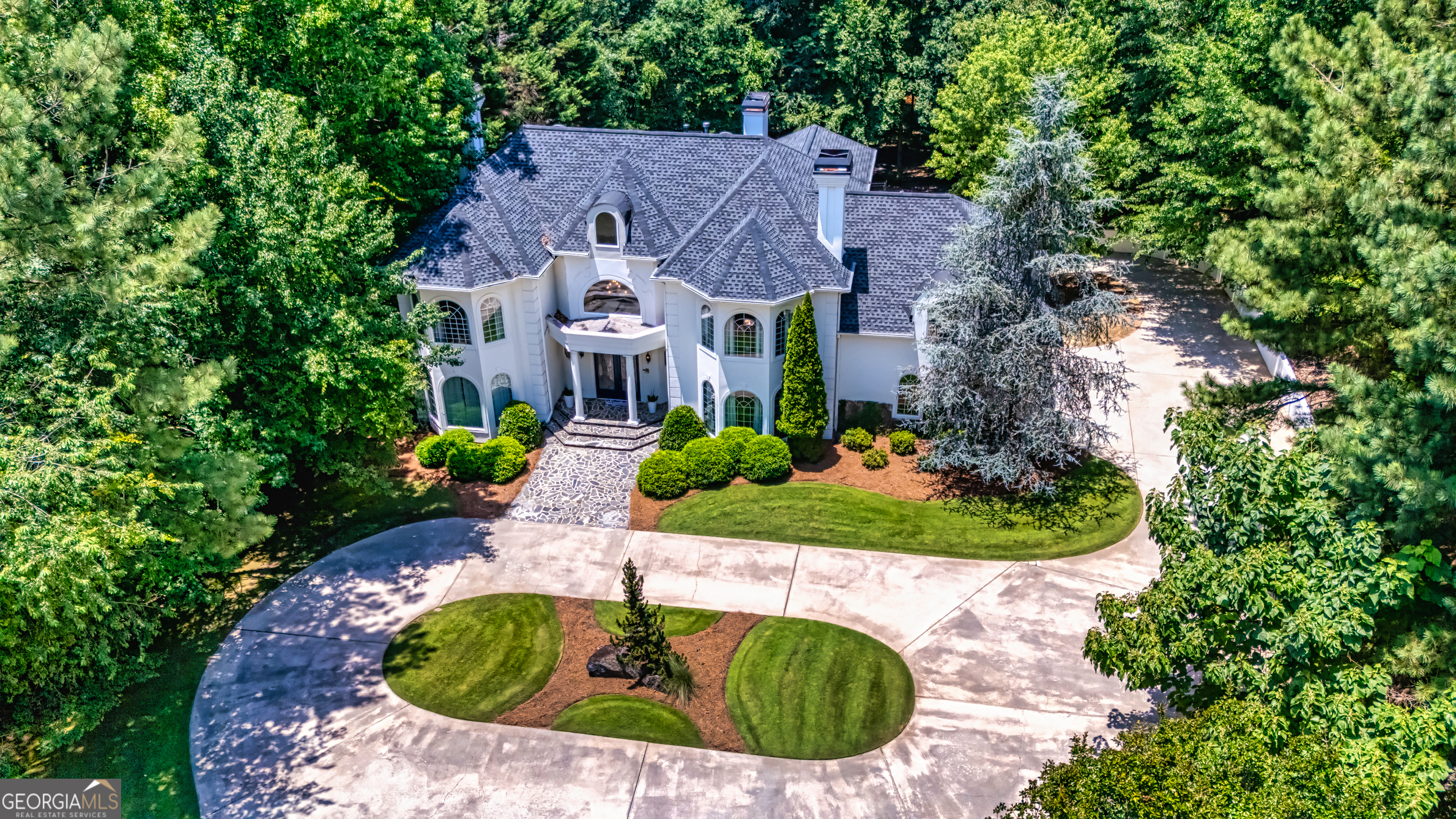 Stately Lake Kedron Area Estate in Smokerise Plantation. Stunning 5BR, 5 full + 2 half-bath European-style estate steps from Lake Kedron in one of Peachtree City's most sought-after neighborhoods. This elegant home offers over 8357+/- sqft of luxury living across three levels with multiple fireplaces, soaring ceilings, and panoramic views of the creek directly behind the home, plus seasonal lake views. Main level features a 2-story travertine foyer, formal dining, living and family rooms, den/office, guest suite with bath, sunroom with hot tub, and chef's kitchen with breakfast area. Upstairs, the private primary suite includes a fireplace, travertine balcony, dual custom (his/her) ensuites, and a private sauna. Two additional bedrooms share a Jack & Jill bath. The finished terrace level includes a great room, home theater, music/flex room, workout room, craft/sewing room, guest suite with bath, full kitchen, and golf cart garage with additional storage. Step outside to a covered patio, in-ground pool with spa - all backing to a creek flowing into lake Kedron and with direct access to 100+ miles of Peachtree City's golf cart paths. This home offers a rare blend of privacy, convenience, and luxury-just steps from Lake Kedron and minutes from Trilith Studios, ATL Airport, and top schools. This property is more than a place to live - it's a lifestyle. Schedule your tour and fall in love.