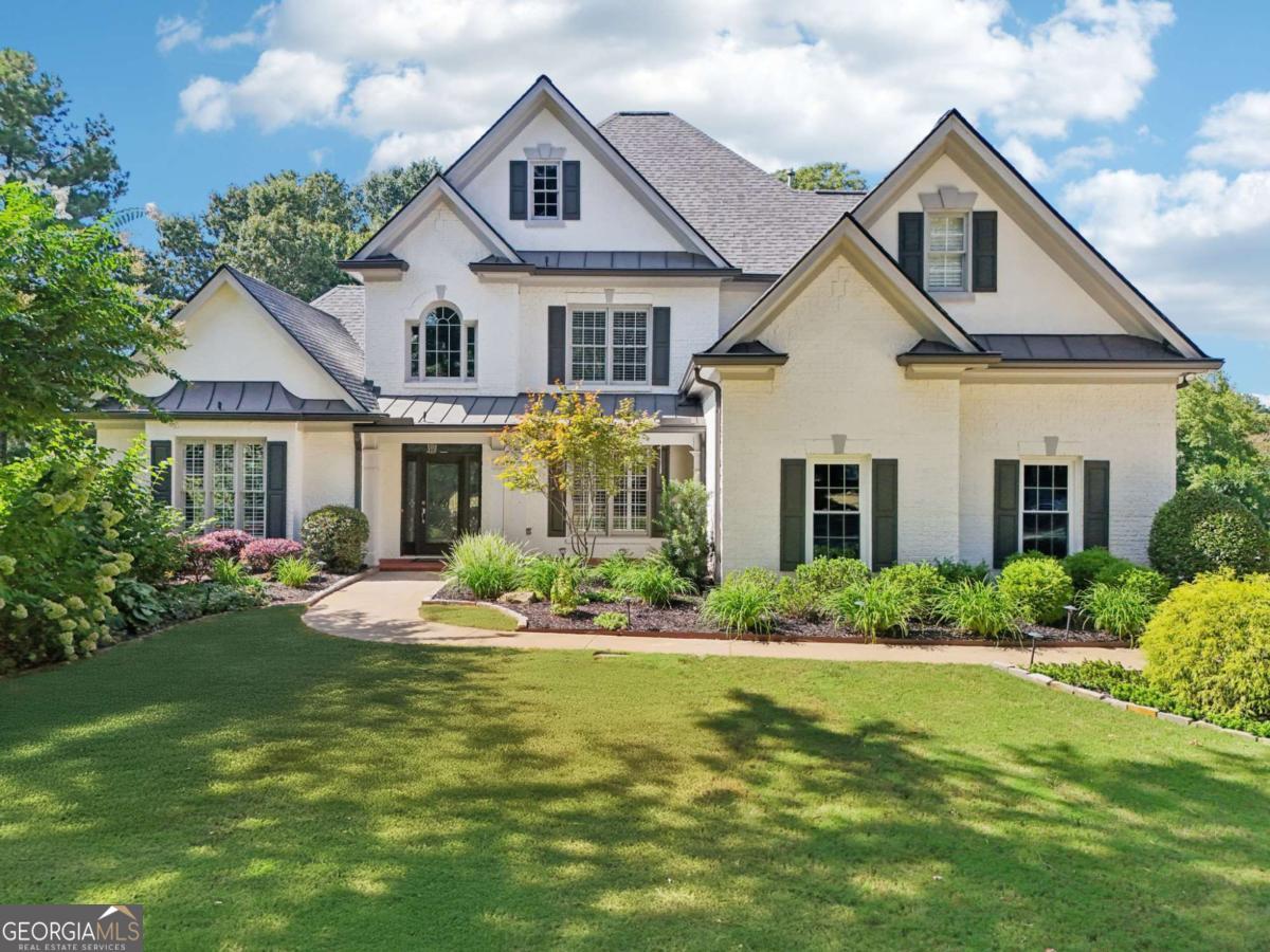 Welcome to this beautifully updated home in the highly sought-after Grand Veridian neighborhood. Nestled on three-quarters of an acre on a flat, level cul-de-sac lot, this rare opportunity offers 5 bedrooms, 5.5 bathrooms, and a three-car garage in one of the area's most desirable communities. Step inside to a welcoming two-story foyer with tall ceilings and light-filled spaces throughout. The main level features a spacious primary suite with tray ceilings, a large walk-in closet, and a spa-like bathroom complete with a soaking tub, double vanities, and a tiled shower. An additional ensuite bedroom on the main level provides flexibility for guests or multigenerational living. Upstairs, you'll find three generously sized bedrooms, each with its own private bathroom. The heart of the home is the updated kitchen, completely remodeled in 2023, opening to the living and dining areas for effortless entertaining. Recent renovations also include all main level bathrooms (2023), new hardwood floors (2023), fresh interior paint (2025), new carpet upstairs (2025), plus new HVAC, furnace, water heater, and front yard sod (2025). A large outdoor patio overlooks the tree-lined backyard, offering both privacy and space to relax or host gatherings. Grand Veridian is an active swim and tennis community, located just minutes from Roswell, Alpharetta, Milton, GA-400, and within a top-rated school district. With limited opportunities to own in this neighborhood, this home is truly a must-see.
