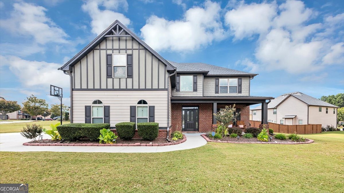 Come sit in the rocking chairs on the front porch or relax on the back extended deck of this stunning European Traditional home in the Grayson District!!! Step inside this 2-story foyer home featuring hardwood floors on the entire main level, crown molding and architectural arches. The kitchen features a ton of stained cabinets with a double oven and eat in kitchen area with a bay window and overlooks the family room with the cozy stone fireplace. The dining room is stunning with coffered ceilings and chair rail molding. The large master bedroom and bathroom are amazing. The master shower with new porcelain tile and new frameless glass was replaced in 2024. Beautiful community, sidewalks, LED street lights, Playground and Pavilion area. Professionally landscaped (park like) yard with new sod on one side, newly planted crape myrtles and large private fenced backyard. The extended driveway and patio was added in 2023. Remote control blinds for upstairs foyer window and ceiling fans in all rooms. Smart home with remote thermostat, security system, ring camera over garage, front door keypad and doorbell camera. Agent-owner.
