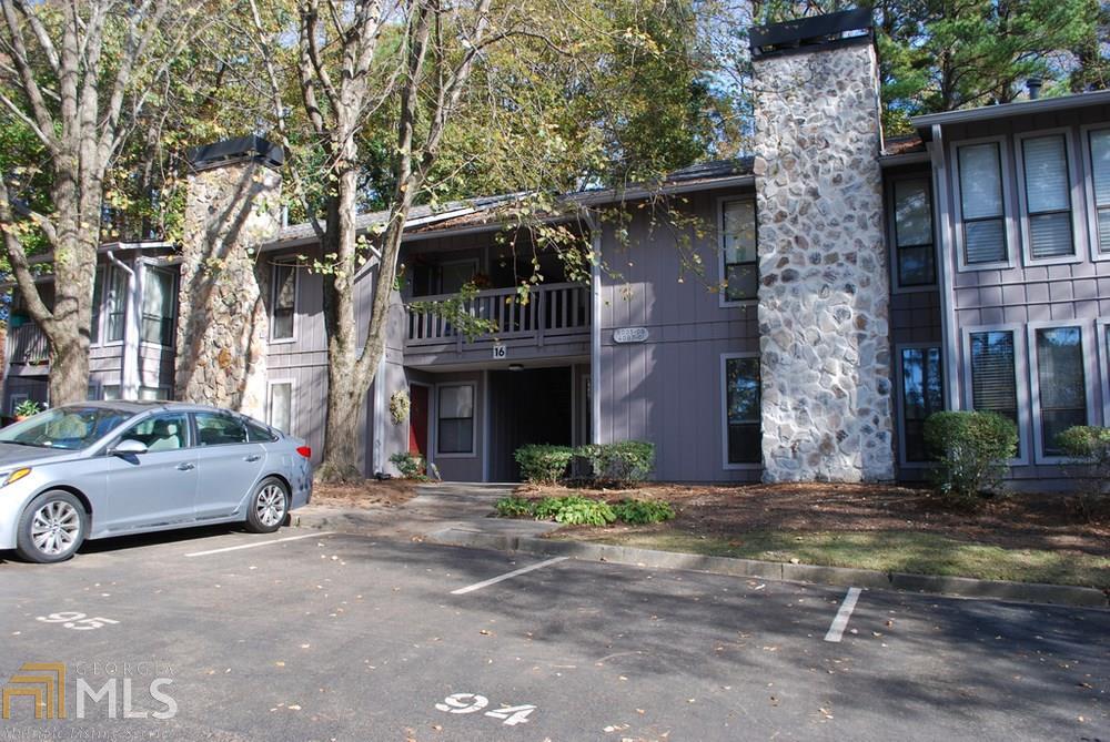 Truly a stepless entrance, back of the building facing a nice wooded and private area. Sparkling clean and super well maintained and upgraded. All appliances 2-3 years of age, all light fixtures upgraded with LED for energy efficiency, average electric bill $45 and gas $35, mirrored walls in dining room, beautiful tile back splash and walls in bath, new carpeting in living room, wood floor in dining room, added shelving in laundry and closets, new flooring in kitchen and laundry, recently painted interior, Nest thermostat, over and under counter lighting in kitchen, one of the very best and brightest units in desirable Woodridge, gated community, saltwater pool, tennis court, well managed community close to I-85 and 285