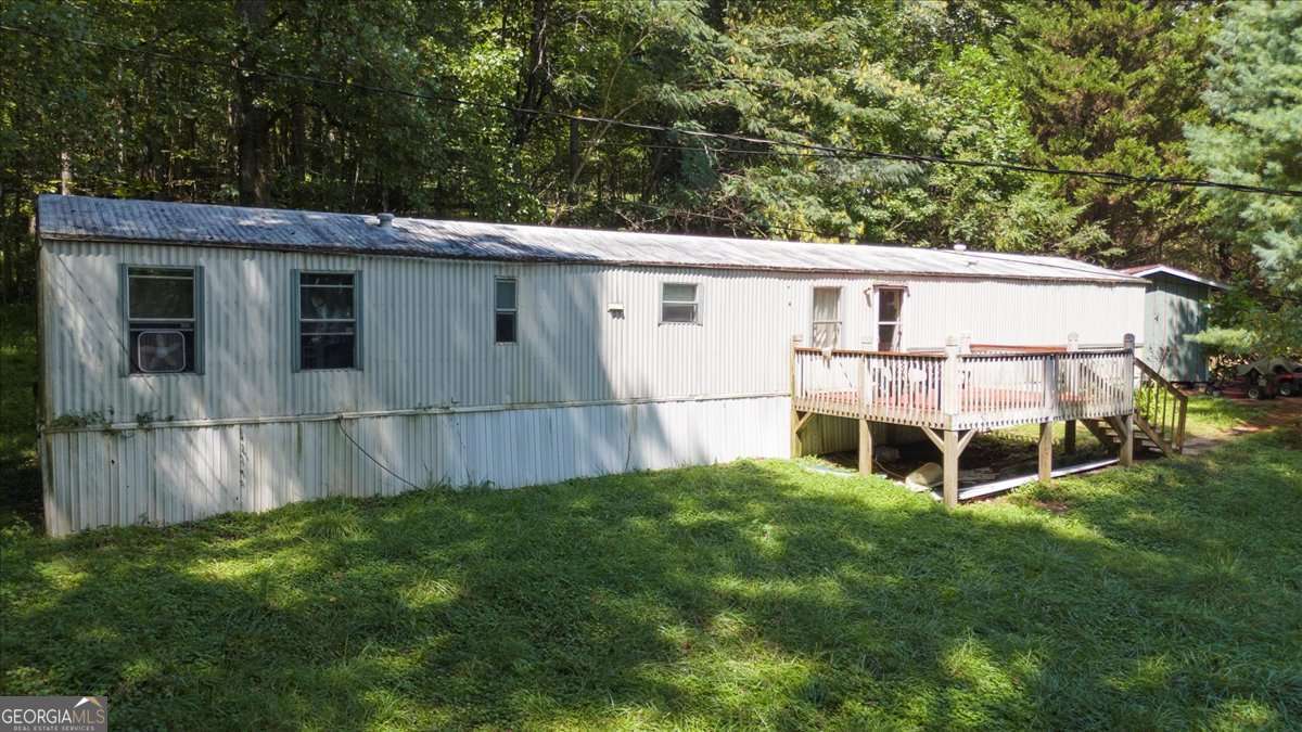 What a great opportunity to own 5+ acres of property in Dahlonega that already has a well and septic. There is currently an occupied mobile home on the property. This is a rural property, surrounded by very nice homes and only 3 miles to Monteluce winery, one of the premier wineries in North Georgia. The land is mainly cleared and lays beautifully. It has recently been staked and flagged which makes it very easy to see the property lines. You could build a lovely home and possibly use it as a short term rental for those seeking the North Georgia Mountains and all of the hiking, waterfalls and wineries nearby. Please park at the street to walk the property lines and do not disturb the tenants.
