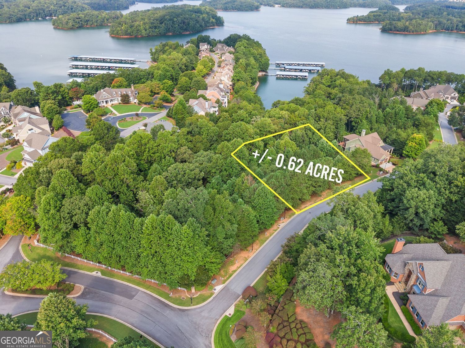 Discover a rare opportunity in the prestigious Harbour Point Yacht Club-a .62 acre combined double lakefront lot with a boat slip option. Not all homes in this luxury gated community on Lake Lanier have slips, making 3525 Water Front Drive one of the most desirable homesites available. Ideally positioned within walking distance of the clubhouse, pool, fitness center, and marina, this property offers unmatched convenience and lifestyle. The wide double lot and natural topography are perfect for designing a terrace-level home with soaring ceilings and seasonal lakefront views. Example design plans are available, and neighboring homes along Water Front Drive showcase just how stunning this property can become. Life in Harbour Point feels like resort-style living every day. Enjoy the newly renovated clubhouse with panoramic views of Lake Lanier and the Blue Ridge Mountains, relax by the sparkling waterfall pool, or join in on the neighborhood's active social calendar. Amenities include tennis, pickleball, and basketball courts, a fitness center, playground, walking trails, and a lakeside pavilion. Golf cart paths make it easy to reach your covered boat slip (H-16) and the marina, complete with day-use courtesy moorings and plenty of parking. Harbour Point offers peace of mind with a gated entrance, high-speed fiber internet, and available off-site boat and RV storage. Conveniently located in the central north section of Lake Lanier, residents enjoy quick boat rides to lakeside restaurants and marinas, plus easy drives to Gainesville, Dawsonville, and Cumming. Highway 985 and GA 400 are close by, and Atlanta is just 55 miles south. 3525 Water Front Drive isn't just a lot-it's an extraordinary chance to build your dream home on a double villa lot with boat slip available for immediate use in North Georgia's premier lakefront community. Here, luxury, recreation, and connection come together for the ultimate Lake Lanier lifestyle. -