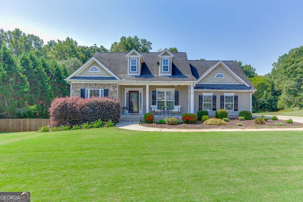 Welcome home to 131 Wood Cove in Jefferson, GA where this beautiful home sits on a large 1.73-acre lot located in the Wood Farm community. Come right in through the charming front porch where you will be greeted in the nice Foyer. The bright Primary Bedroom with vaulted ceilings is conveniently on the main level. Enter the stunning updated Primary EnSuite through the sliding barndoor to see gorgeous, tiled shower with glass doors, ship lapped accent wall, garden tub, beautiful cabinetry, countertops, and details galore. Across the home you will find two Secondary Bedrooms, a full Bathroom, and a Laundry Room with a window. In the heart of the home, you will enjoy the tiled Kitchen, Breakfast Room, and Family Room all open that makes it perfect for entertaining. Through the Kitchen you will find the beautiful Dining Room for the best place to share a special meal. Upstairs is a Bonus Room great for a playroom, office or guest bedroom. In the partially finished Basement, you will have even more space with another large Family Room with a fireplace, another Bonus Room, and a Full Bathroom. This basement has so much storage space, as well as a workshop that is set up for a woodworking vacuum. Enjoy time outside on the large deck looking out in this huge yard that is just right for outdoor gatherings and wrapping up your evening around the big firepit area. Come tour this home and dream of making memories of your own at 131 Wood Cove!
