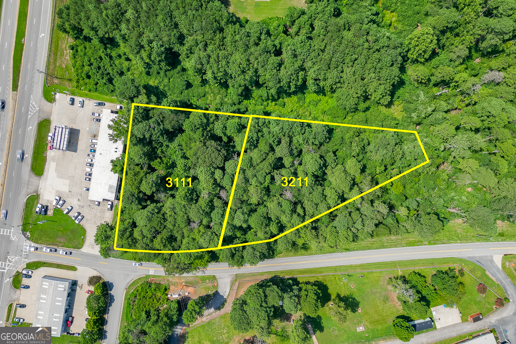 This outstanding commercial opportunity is ideally situated along Highway 53/McEver Road, directly across from Free Chapel in Gainesville. The property includes two level parcels at 3111 and 3121 Gould Road, offering nearly 300 feet of prime road frontage. Surrounded by wellestablished neighboring businesses-including a strip center, gas station, auto repair shop, fire station, and elementary school-the site benefits from a strong commercial presence and community activity. With all utilities readily available at the road and exceptional visibility due to McEver Road's high traffic volume, this location ensures both convenience and accessibility for a variety of commercial uses. Whether for development or investment, this site offers significant potential in one of Gainesville's most active corridors.