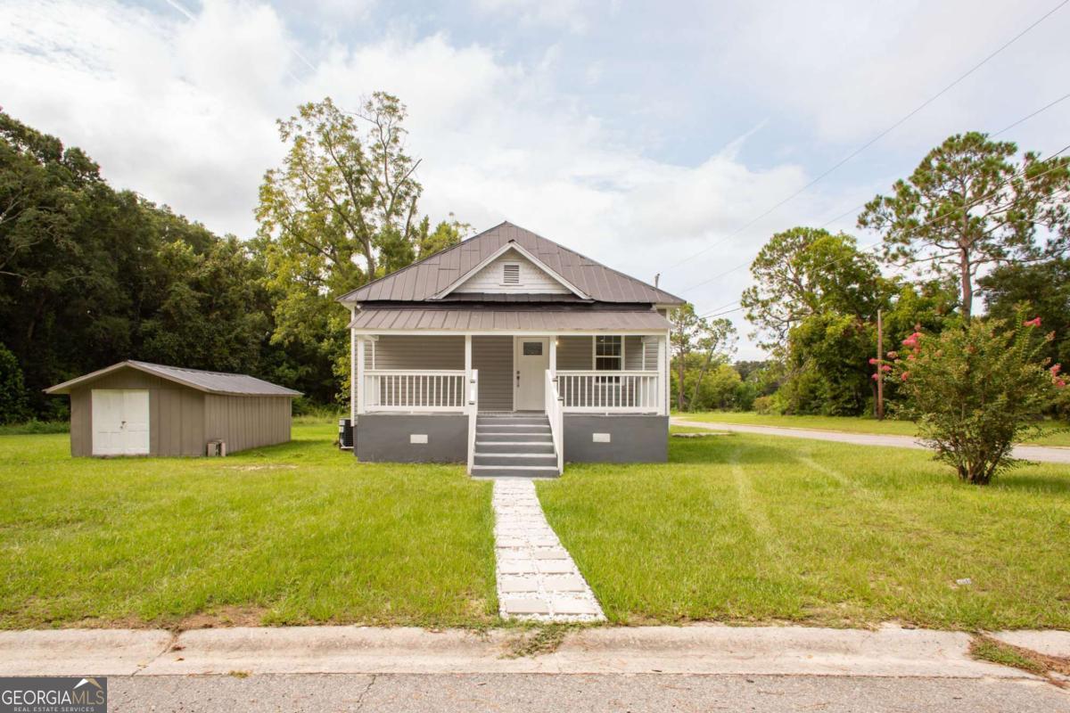 Step Inside this charming 1905 Cottage with Original Features and Modern Updates in Ware County GA .This delightful 3 bedroom 2 bath home is nestled in the heart of Waycross, GA. This home exudes vintage charm while offering the convenience of modern living. Seller has renovated to make for a more functional space, but keeping the charm that you will love. The kitchen has a perfect size island, beautiful countertops, New Cabinets , New Appliances and is open to the living room and dining allowing for ease of entertainment. Updates to Electrical and Plumbing as well as a New HVAC and Water Heater. Grab a book, your coffee, or just unwind and enjoy the small town life from the relaxing front porch. Beautiful corner lot also features a extra building that can be used for a workshop or storage. Don't miss out on this