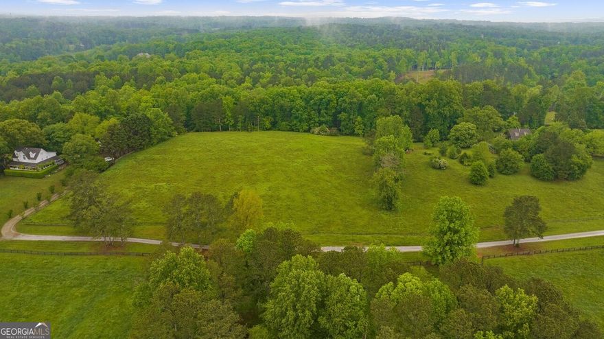 Discover 4.89 acres of prime land in one of Cherokee County's most desirable locations, featuring the convenience of an Alpharetta address. Nestled on a gentle rise, this parcel captures breathtaking views and offers a tranquil setting with a balance of pasture and mature hardwoods. The property provides an ideal homesite for a custom estate, weekend getaway, or future investment. Enjoy the privacy of acreage living without sacrificing proximity to excellent schools, shopping, and dining   a rare opportunity to create something truly special.