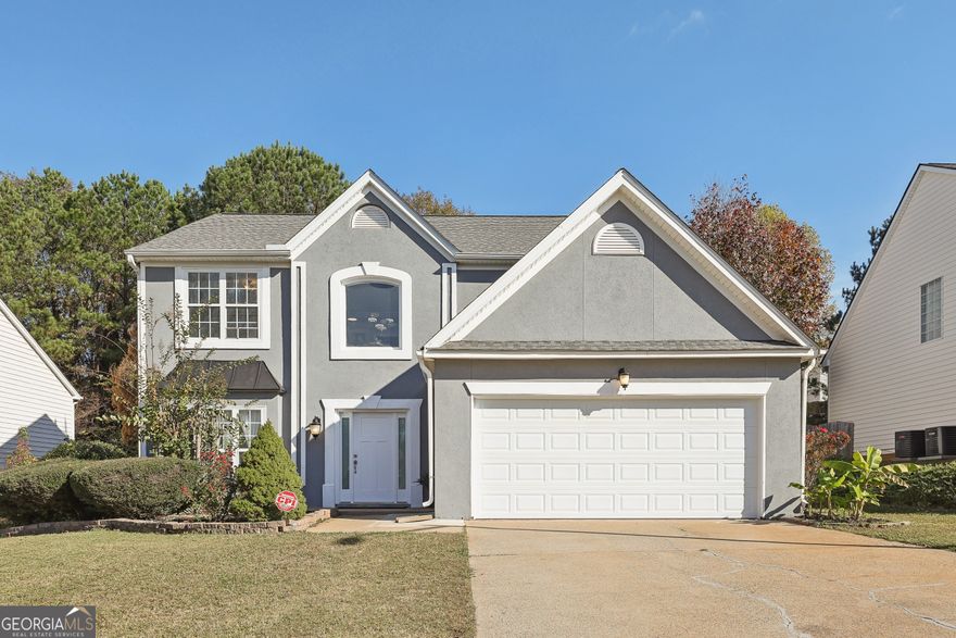 Welcome to Your Dream Home! Modern living meets comfort in this beautiful 3-bedroom, 2.5-bath home, ready for you to move in and start making memories. Freshly painted inside and out, it boasts a stunning kitchen with brand-new quartz countertops, white cabinetry, a gas cooktop, and a versatile island perfect for hosting casual meals. Stylish tile flooring flows through the first floor, while a cozy living room with a fireplace invites relaxation. Upstairs, spacious bedrooms offer personal retreats.  Step outside to a newly extended, covered deck overlooking a private, fenced backyard. Major improvements include Roof (2023), HVAC System (2023), and a NEW Garage Door(2024), NEW Oven (Jan 2025). With these updates, you can move in with peace of mind and start enjoying your new home right away. If location matters, this home is just minutes from Marietta Square, Jim R. Miller Park, schools, shopping, and dining. Its prime location offers the ideal balance of suburban tranquility and everyday convenience.  Don't wait-schedule your showing today and make this beautiful home your own!