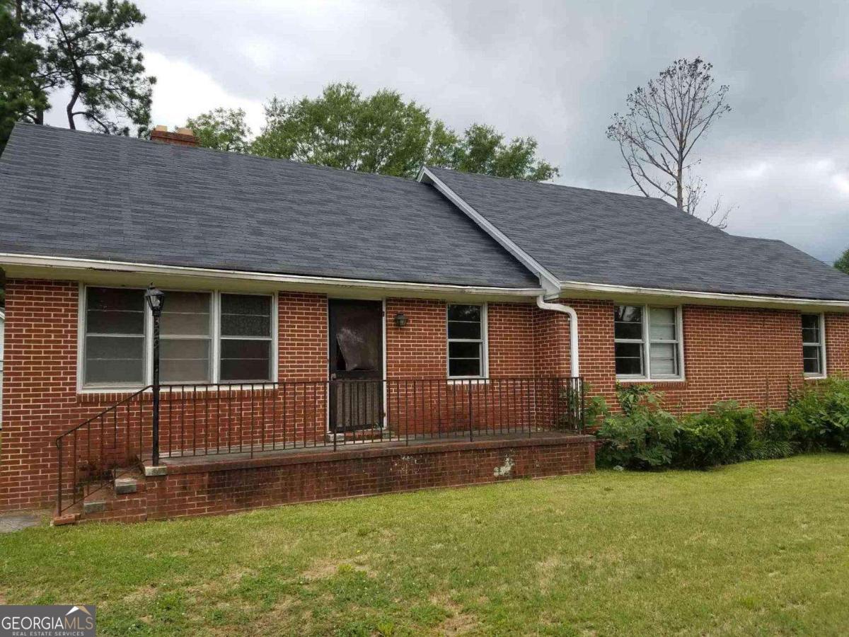 Cute 4 sided brick ranch with original hardwoods. Large level lot. Zoned residential/professional. Sold AS IS.