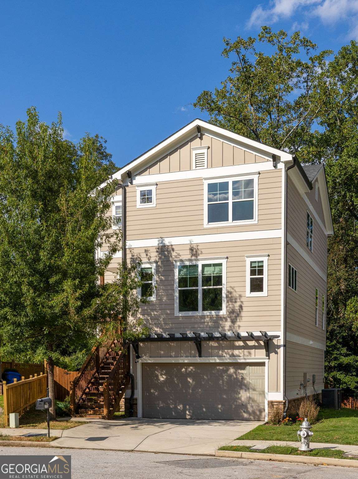 Tucked at the end of a peaceful cul-de-sac, this 4-bedroom, 3.5-bath craftsman offers the best of both worlds: a sense of retreat surrounded by a welcoming neighborhood. Built in 2021 on an oversized wooded lot, it combines comfort, community, and convenience within the highly regarded Burgess-Peterson school zone. Just a short stroll away, East Atlanta Village provides endless dining, shopping, and festivals, while at home you'll enjoy the balance of quiet surroundings and easy connection. Inside, thoughtful design and flow create spaces that feel both polished and inviting. Upgrades include hardwood floors throughout and fresh interior paint in every room. The chef's kitchen, complete with quartz countertops and custom tile seamlessly connects to a spacious living room anchored by a gas fireplace, with a separate dining room designed for gathering. Upstairs, find three bedrooms including the primary suite that showcases vaulted ceilings, a generous walk-in closet, and an oversized double shower. The lower level provides flexibility with a private bedroom and landing - ideal for hosting guests, creating a home office, or carving out a dedicated retreat. Out back, the home opens to a true entertainer's dream: an expansive deck for outdoor dining, a fenced yard for play and relaxation, and plenty of space to gather beneath the trees. A two-car garage adds convenience and storage, rounding out the ease of everyday living. Here, you'll find walkability to East Atlanta Village, proximity to the BeltLine, and quick access to major highways, placing the entire city within easy reach. This home offers not just a place to live, but a lifestyle that balances privacy, connection, and the best of Atlanta living.