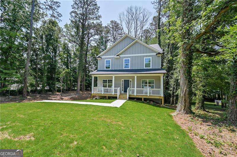 New construction just a mile from downtown Acworth! This craftsman style home features an open concept floor plan with large island and hardwood style flooring throughout main level. Designer black fixtures create a beautiful modern feeling to entertain guests. Bedroom on the main level with full bathroom is perfect for a guest or in-law suite. Enjoy the large back deck for outdoor grilling, or sit on the rocking chair front porch. Upstairs features an additional 3 spacious bedrooms, with the master suite offering a large, brand new bathroom with double vanity and soaking tub. Back yard has been landscaped with underground draining and is ready to be seeded and fenced! Quick access to 75 makes this an ideal location!