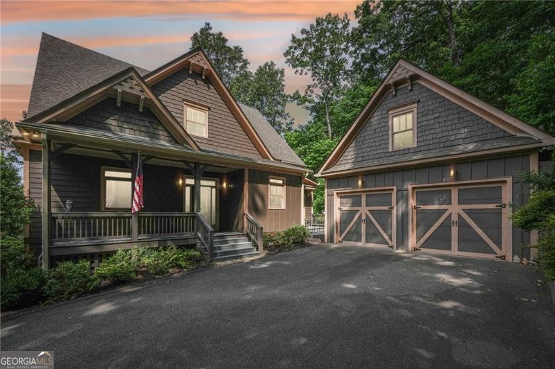 Stunning Move-In Ready Custom Home with seasonal Mountain Views, and two car detached garage. Step into this exceptional home, perched on a picturesque knoll, where you can soak in brilliant sunsets, crisp mountain air, and peaceful surroundings. Designed for seamless indoor-outdoor living, it boasts two expansive decks and a spacious screened porch featuring EZ Breeze windows and vinyl flooring for year-round enjoyment. Main level deck recently converted to Trex decking. New Lennox 18.0 Seer heat pump installed Jan 2023, new washer and dryer. The master closet has been upgraded with custom shelving. Owners added "Big Tex" gas logs to the main level fireplace. Inside, luxury and comfort meet with a completely remodeled kitchen showcasing quartz and marble countertops, a sleek white subway tile backsplash, a high-end Viking gas cooktop, and stylish cabinetry. Hardwood floors through out main floor area and master suite. The open-concept living space is enhanced by soaring 10-foot ceilings, a wall of windows, and a striking stone fireplace, creating a warm and inviting atmosphere. Upstairs, guests will feel right at home with a spacious office/sitting area with its own fireplace, two additional bedrooms, and a full bath plus two half baths. For energy efficiency, the west-facing windows feature solar tinting. Entertainment lovers will be thrilled with the terrace level, where 10-foot ceilings provide an airy feel. This space includes a guest bedroom and bath, a generous family room with a stone fireplace, and a game area complete with a pool table, wet bar with granite countertops, and wine cooler, perfect for hosting unforgettable gatherings.