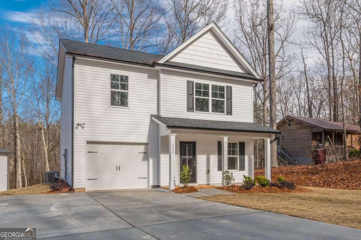 Nestled on a beautiful wooded lot across the street from the serene shores of Lake Lanier, this stunning new construction home on a full unfinished basement offers an open floor plan perfect for modern living. Located in highly sought after East Forsyth High School District, this 3BR/2.5BA new home will be completed Oct 2025. The main level features an open-concept layout, ideal for entertaining guests or relaxing with family. The well-appointed kitchen is complete with SS appliances, quartz counter tops, tile backsplash, white shaker cabinets, LVP floors t/o the entire home, and ample countertop space. The spacious master bedroom features a vaulted ceiling, his and her closets, and is located on the other side of the secondary bedrooms. The master bathroom contains a shower/tub combo and separate his and her vanities as well as a large walk in closet. A full, unfinished basement allows for future expansion. Conveniently located near Cumming, Gainesville, and Dawsonville, you'll have easy access to shopping, dining, and entertainment options. Pics are not of actual home but of similar floor plan and finishes. Agent/owner.