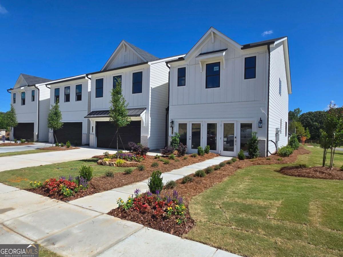 Now Selling in Sherwood Square - New Townhomes in Flowery Branch! Be among the first to own in Sherwood Square, a brand-new townhome community by Century Communities, offering pre-grand opening pricing you won't want to miss! Conveniently located in Flowery Branch, you'll enjoy easy access to shopping, dining, and all the outdoor recreation Lake Lanier has to offer-just minutes away. This featured home showcases the popular Sawnee floor plan, a thoughtfully designed 3-bedroom, 2.5-bath townhome with 1,855 sq ft of open living space. Step inside to find a spacious kitchen complete with quartz kitchen countertops, stainless steel Whirlpool appliances (including a range, exterior-vented microwave, and dishwasher), and a single-bowl stainless steel sink-perfect for both cooking and entertaining. The open-concept layout flows seamlessly into the dining and family room areas, with easy access to a backyard that can be fenced in, ideal for pets or privacy. Upstairs, the oversized primary suite features a walk-in closet and a private en-suite bath, while two additional guest bedrooms share a full bath-ideal for family, guests, or a home office setup. A 2-car front-entry garage adds extra convenience and curb appeal. Ask about our financial offerings and promotions with use of Inspire Home Loans! Pre Grand Opening Pricing! Showings by Appointment only! Sherwood Square residents will enjoy planned community amenities including a swimming pool, cabana, pickleball courts, and a playground-creating the perfect blend of comfort, recreation, and lifestyle. Don't miss your chance to own a brand-new home at a fantastic value in one of Flowery Branch's most desirable locations.