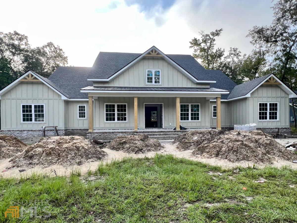 Stunning New Construction 4BR/3.5BA home PLUS Office with 3-car garage! This beauty features Board N'Batten Siding & Brick foundation accent, spacious front and Back porches, Tankless Gas Water Heater, Spray Foam Insulation and attention to detail everywhere. The interior offers an open floor plan with enclosed office/hobby room and split bedroom plan. The Living Room will be painted SW Sea Salt and will have crown molding. The kitchen features Whirlpool Stainless Appliances to include a Gas Cooktop w/custom Wood Hood w/vent, wall oven, microwave, dishwasher. Kitchen cabinets are Shaker style, Sherwin Williams Snowbound white and countertops to be Ashen Grey Quartz/Island will be Butcher Block wood to match Pantry tops. The Primary Bedroom ensuite bath features Calcatta Polished Tile Shower, white Shaker Cabinets, Quartz countertops and a Walk-in Closet. Estimated completion date November 1-15th. Barrington Oaks is a luxury Gated Community, curb & gutter paved streets, public utilities and protective covenants. Zoned schools are some of the highest ranking in Glynn County. RBUI100023
