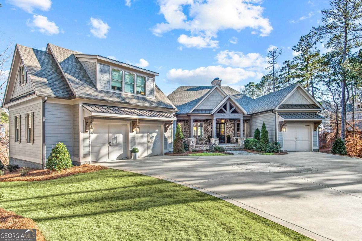Luxury Lakefront Home with Private Max Dock, Lakeside Pool & Prime Location Near Richland Pointe Built in 2020 by Bob Hatfield and upgraded in every way, this move-in-ready lakefront masterpiece in the Reynolds Lake Oconee Community offers an executive-level lifestyle with unmatched luxury, comfort, and convenience. Situated on a prime lot with breathtaking water views, this home boasts a private max dock, providing effortless lake access for boating, fishing, and water sports. Designed for both full-time living or as a perfect second home retreat, this exceptional residence features top-tier upgrades throughout, from high-end finishes and custom millwork to a main level all season porch complete with wood burning fireplace, smokers and gas grill. Perfect for relaxation and entertaining. The walkout terrace level seamlessly extends to a lakeside oasis, complete with a resort-style pool, hot tub, a max dock with boat lift and two jet-ski lifts offering the ultimate setting for fun in the sun. Located within an easy 1 mile walk to Richland Pointe, the most coveted area of Reynolds. Reynolds Lake Oconee membership is available to enjoy access to premier golf courses, fine dining restaurants, world-class spa, and resort-style pools. This home's sophisticated design, expansive open floor plan, and breathtaking lake views make it the ideal choice for discerning buyers seeking a luxury lakefront lifestyle. A rare and extraordinary opportunity to own one of the finest homes in Reynolds Lake Oconee-experience the perfect blend of elegance, comfort, and lakeside serenity today!