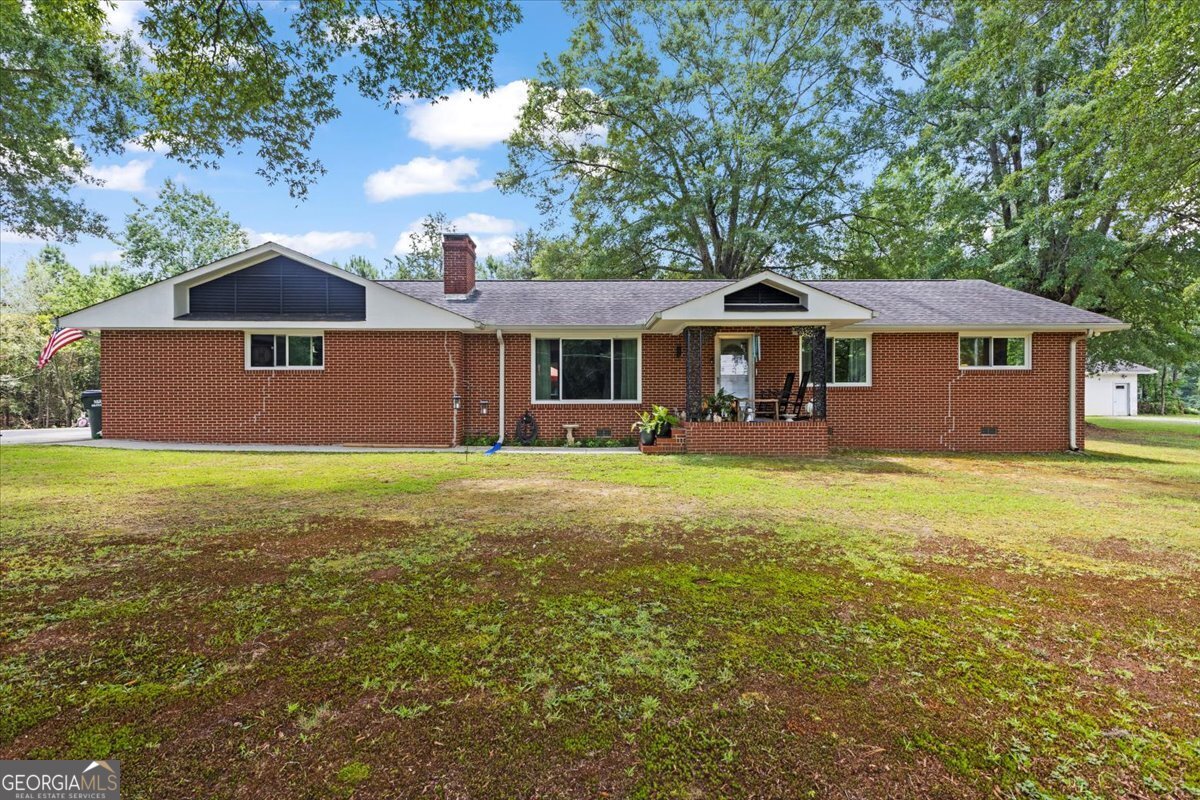 PRICE IMPROVEMENT- SELLER MOTIVATED... Seller is offering a 1 year home warranty with full price offer! Yes, you heard that correctly, a 1 YEAR HOME WARRANTY with full price offer!! Upon entering the property you will notice this beautiful brick rancher home, tucked away in beautiful hardwood trees to give it lots of shade in the summer where you can sit and look out the picture window and watch the wildlife while drinking your favorite beverage. Featuring new windows, new fenced in lot in the back yard, has large side yard that is not fenced in however would be a great place for kids to play or building, new ceiling fans, new electrical and plumbing work completed. This home also has hardwood floors throughout, natural gas fire place, large laundry room, master bed w/bath, vintage tile in both bathrooms on almost a acre lot. Come fall in love with this peaceful oasis. Seller is motivated due to relocation!
