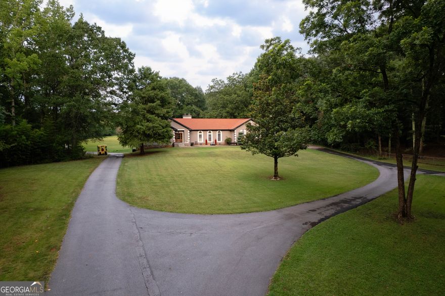 ***Open house Saturday 9/20/2025 1-3. ***Welcome to this exceptional estate, perfectly situated on 8.21 private acres in the highly sought-after Union Grove school district. From the moment you arrive, the quality and care poured into this immaculate home are undeniable. Thoughtful upgrades and elevated designer finishes are found throughout, with a chef's dream kitchen at the heart of the home - ideal for both everyday living and entertaining. The luxurious primary suite offers a true spa-like retreat with its stunning stone freestanding tub, oversized 7-foot shower with dual rain heads, and elegant finishes throughout. Rich hardwood floors flow seamlessly across the main level, complemented by two inviting wood-burning fireplaces that add warmth and charm. The terrace level offers a fully equipped second kitchen featuring granite countertops, a leathered granite island, farmhouse sink, full-size pantry, dishwasher, and space for a full-sized refrigerator - providing true independence and flexibility. This level also includes spacious living and dining areas, a generously sized bedroom, and an oversized bathroom with double vanities - making it ideal for in-laws, guests, or even income potential. With its own laundry and private entrance, this space feels more like a second home than a basement. Step outside and you'll discover outdoor living at its finest. A sparkling above-ground pool with surrounding deck, a relaxing hot tub, and a charming pergola with natural stone fireplace create the ultimate entertaining space for gatherings year-round. Additional highlights include a 2-car attached garage, 2-car detached garage, and a 1,500 sq ft unfinished area with drive-in boat door - perfect for storage, hobbies, or future possibilities. Zoned AR, horses are welcomed, and a barn is already in place. This rare offering blends luxury, privacy, and versatility in a picturesque, highly desirable location.