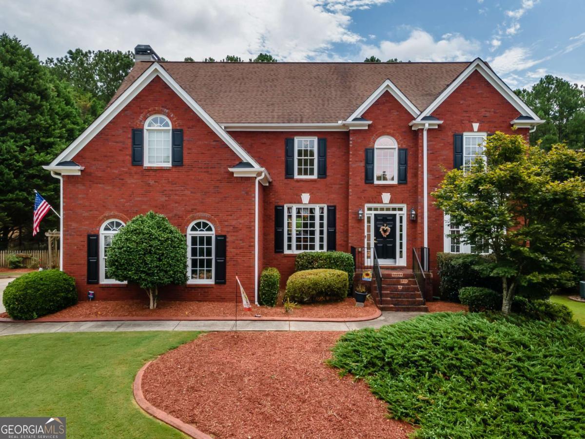 Location and lifestyle combine to make this your next dream home! Just off Towne Lake Parkway and 575, this meticulously-maintained 4 bedroom home with a luxurious POOL and finished terrace level is ready for you! Beautiful, pristine landscaping greets you as you pull up to this stately home. The grand entry foyer opens up into the lofty great room with the first of THREE FIREPLACES, and big enough for a grand piano! The kitchen is large and finished with high-end cabinets and counters. You'll love the sitting area/eat-in kitchen with another fireplace. From there step out into the backyard oasis, where you'll find the lovely POOL, deck, and private fenced yard. The large separate dining room allows for plenty of seating; sure to please the entertainer. Before you head upstairs, notice the bedroom on the main level, just off the great room; perfect for guests or as an office. Upstairs are three more bedrooms, including the OVERSIZED PRIMARY ensuite with the third fireplace. So much space...and the closet is a room unto itself. The two secondary bedrooms are nicely sized with plenty of closet space. Heading to the FINISHED BASEMENT, you'll find a large LIVING area, full bath, and plenty of storage. There is also a BOAT GARAGE on this level - accessible from inside and outside the home. Don't delay...schedule your private showing today!