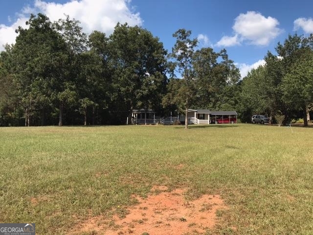 This 3 acre tract is located in the rapidly developing area of Butts/Spalding county only 3/4 mile from the I-75 and GA Hwy 16 intersection. It provides an excellent location for commercial/industrial use. It fronts along the West bound lanes of Hwy 16/Arthur K Bolton Pkwy on the Griffin side of I-75. Over 300 feet of highway frontage. This property has access to all utilities whit sewer being only about 500 feet from the property and includes a 1500 sqft home structure that could serve the owner well as an on-site office. The home is currently served by a well and septic tank system.