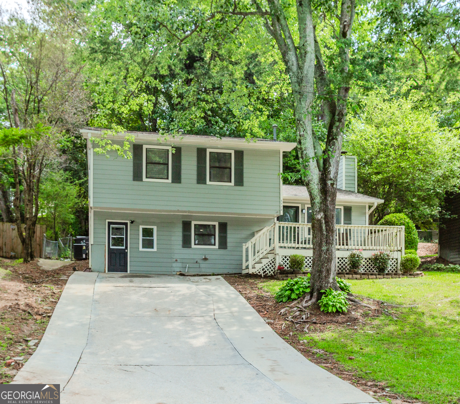 Don't miss this beautifully remodeled split-level home situated on a spacious and fully fenced lot in the highly desirable Norcross school district. New Roof & New Gutters/Downspouts coming soon. Completely renovated home offers 4 bedrooms and 3 full bathrooms, this home includes a versatile studio apartment with one bedroom and full bath in the enclosed garage-complete with its own mini kitchen with separate entrance-ideal for guests, in-laws, or rental income. The main level features an open-concept great room with a cozy fireplace, hardwood floors, and direct access to the rear patio-perfect for entertaining or relaxing. The updated eat-in kitchen boasts stainless steel appliances and a convenient laundry closet. Upstairs, you'll find three generously sized bedrooms and two updated tiled bathrooms, all with hardwood flooring throughout. An attached 120 sq ft building offers additional storage, hobby space, or home office potential. This property combines space, function, and a prime location-making it an exceptional opportunity in Norcross. Right off Jimmy Carter Blvd at I-85.
