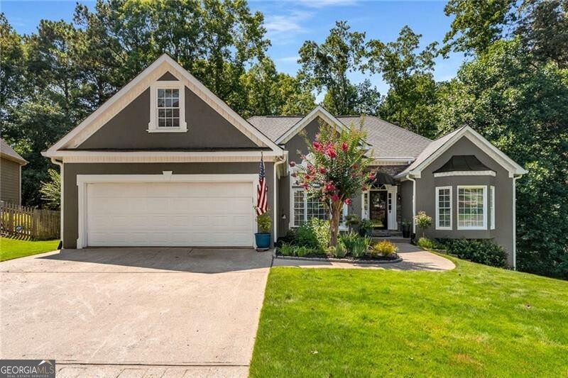 Welcome home to this STUNNING MODERN FARMHOUSE style 5 bedroom 3.5 bath RANCH on FINISHED BASEMENT perfectly situated on a large, private lot with incredible upgrades and timeless charm throughout. This. home is not only gorgeous but it checks all the boxes for systems too! NEW HVAC, NEW WATER HEATER, NEW TREX DECK, NEW UNDERDECK SYSTEM. and IRRIGATION SYSTEM. The heart of the home is the gorgeous, renovated kitchen-a true showstopper-featuring an oversized quartz island, crisp white cabinetry, stainless appliances, custom shiplap walls and ceiling, and designer lighting. It's the ideal gathering place, seamlessly open to the spacious family and dining rooms-perfect for entertaining or cozy nights in. Enjoy the comfort of luxury vinyl flooring throughout, a split-bedroom layout offering privacy, and a bright open-concept design that flows beautifully. The expansive primary suite is a retreat all its own with a tray ceiling, sitting area or office with large built-in storage/closet featuring barn doors and a luxuriously renovated en-suite bath boasting designer subway tile shower, seamless glass, soaking tub, dual vanities, private water closet, and a generous walk-in closet. Two spacious secondary bedrooms and a fully renovated bathroom sit on the opposite wing of the home, while the flexible 4th bedroom/bonus/loft room above the garage features its own climate control and adds options for guests, a home office, teen suite, toddler playroom, craft room, media space or more. The fully finished daylight basement is a true extension of the home for multi-generational use, featuring a custom kitchenette, full bathroom with a 2nd laundry area, a oversized private bedroom, living room, dedicated office space, and direct access to a covered patio with ceiling fan. Don't miss the incredible large workshop with it's own climate control, for the builder, crafter, hobbyist or additional storage. This basement does not disappoint and is a perfect area for entertaining or an in-law suite! Accessible 36" doors for even greater convenience! Step outside to be wowed again with the two-story Trex deck, paver patio, and a dry underdeck system installed in 2023-all overlooking the private, wooded, landscaped, fenced backyard oasis. For the gardener, enjoy an abundance of low maintenance perennials and a beautiful zoysia yard. Easy access to shopping, dining, entertainment, including nearby downtown Woodstock or Canton, and sought after schools. With OVER 200K in UPGRADES, this home blends modern design, comfort, and convenience in a peaceful setting-an absolute must-see!