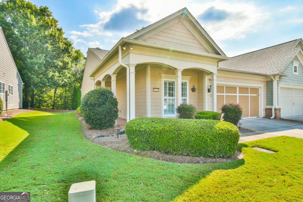 Come see this adorable Muerfield Villa with 2 bedroom, 2 baths, office and picture perfect sunroom. This home has shutters and a doors, in place, on the office. You will also notice the great rocking chair porch, where you can sit and chat with neighbors, or enjoy your coffee. The back yard is good sized for any gardening or fence for your puppy. The HVAC is new and the new washer and dryer are included. Deaton Creek has this special street with duplexes that we call Villas. The Villas take care of the exterior of your home. You will not have to worry about paint, roofs, gutters or landscaping. It is a great way to live your best life and not worry about exterior home maintenance issues. Come see this pretty home today.