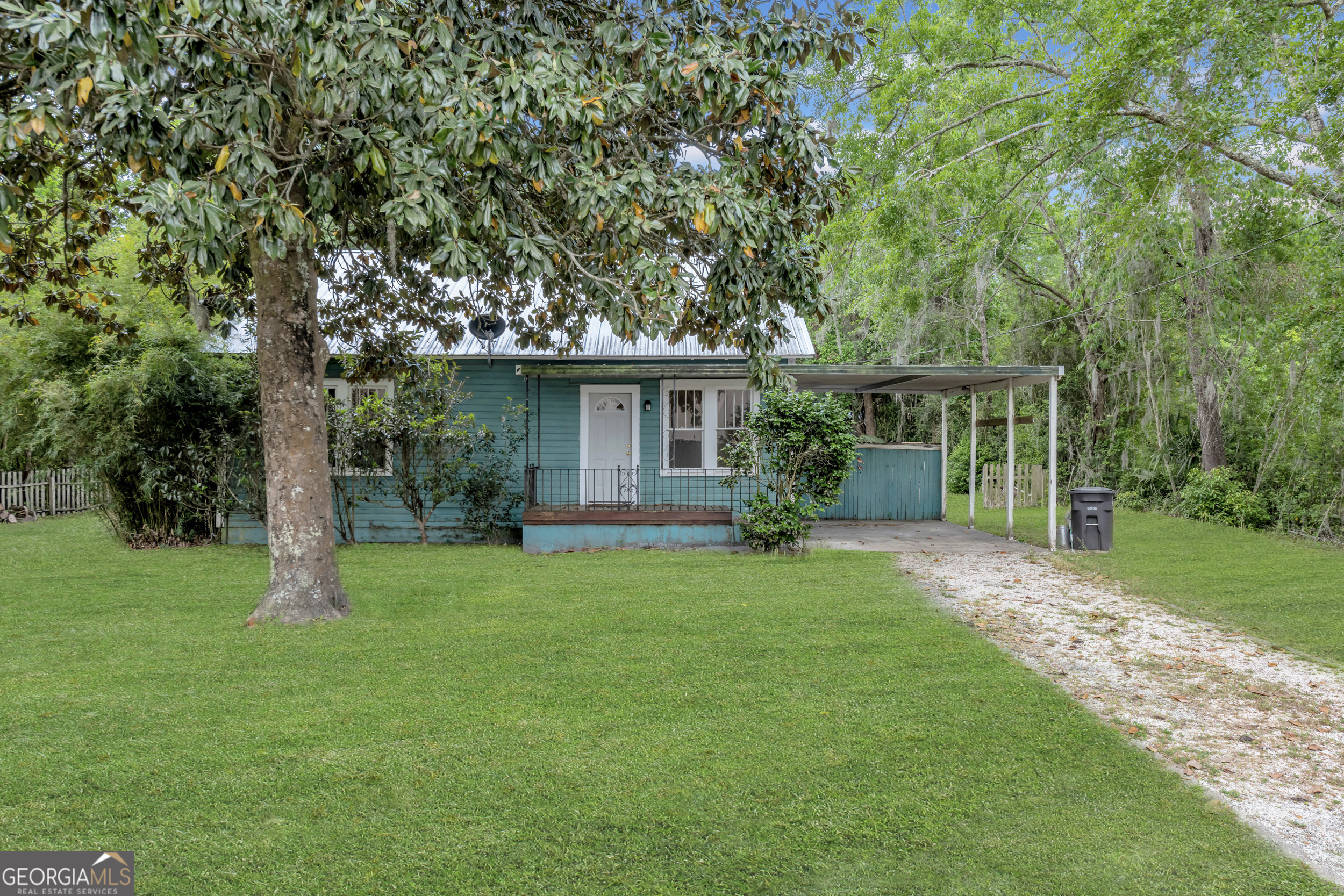 Charming Historic Home in the Heart of Downtown Woodbine! Built in 1900, this absolutely delightful 1,282 sq ft home blends vintage charm with modern upgrades. Lovingly maintained over the years, it's move-in ready and waiting for its next chapter! You'll find character throughout with high ceilings, hardwood floors, a formal dining room, and a cozy breakfast bar with granite countertops. Enjoy the Southern lifestyle from your front porch, or relax in the fenced backyard with a covered storage area behind the carport. The metal roof adds durability and classic appeal. Located just steps from the scenic Satilla River, local parks, shopping, and the beloved Captain Stan's Restaurant. Downtown Woodbine offers small-town charm with convenient access-just minutes from Exit 14 off I-95, between Kingsland and Brunswick. Commuters will appreciate being only 42 minutes from Jacksonville International Airport, 25 minutes from Kings Bay Submarine Base, and 32 minutes to FLETC in Brunswick. This home qualifies for a variety of financing options, including VA, FHA, and USDA loans-perfect for a range of buyers!