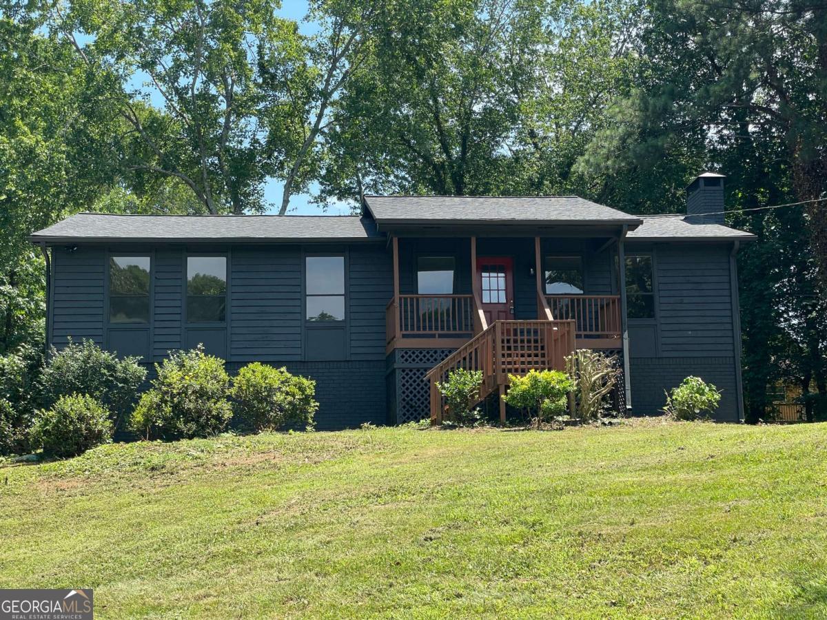 Welcome to this beautifully updated 3-bedroom, 2-bathroom home, ideally located in a quiet cul-de-sac just 5 minutes from I-575 and Downtown Woodstock, offering the perfect blend of style, comfort, and convenience. Inside, you'll find brand new hardwood floors throughout the main living areas and new carpet in the bedrooms. The spacious living room features a stunning painted brick fireplace, creating a warm and inviting atmosphere. The fully renovated kitchen offers modern finishes, ample counter space, and a view of the backyard, with direct access to the outdoor area-perfect for entertaining or relaxing. The brand new primary bathroom boasts a sleek walk-in shower and a double vanity for added comfort. Additional features include a workshop area in the garage, ideal for hobbies or extra storage. This move-in ready home is packed with thoughtful updates and nestled in a desirable location close to everything Woodstock has to offer.