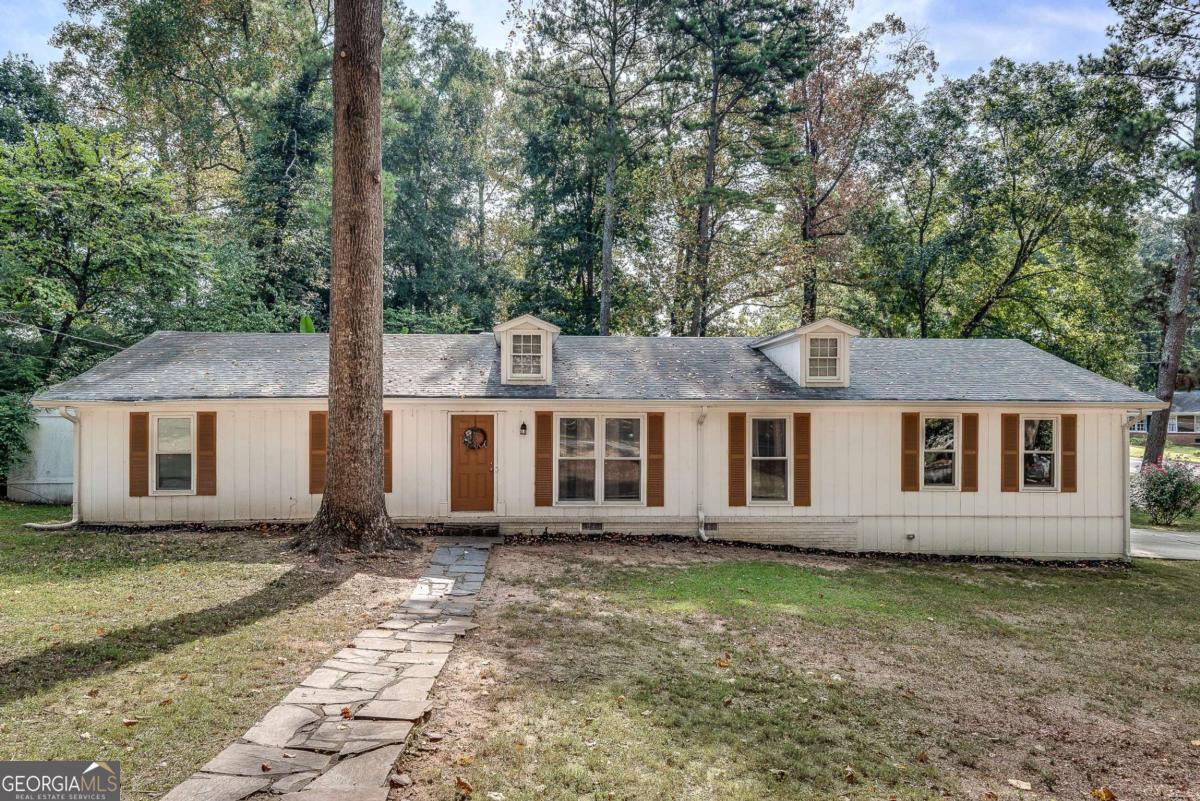 Beautifully renovated ranch with a huge front yard! Step inside to luxury vinyl plank floors and tons of natural light throughout. The kitchen features crisp white cabinets, stainless steel appliances, and a classic subway tile backsplash, with a cozy eat-in area and fireplace that flows right into the family room. Enjoy summer evenings entertaining on the patio, relaxing in the backyard, or soaking up the sunshine in the vibrant sunroom. All this, with a convenient location near Shorty Howell Park, Gwinnett Technical College, and Northside Hospital. Don't miss this one!