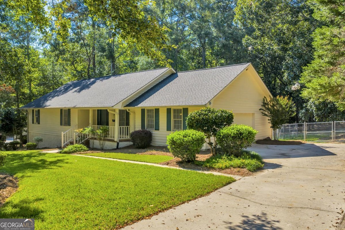 Prime location near Northwest Laurens Elementary and Trinity Schools and minutes from Downtown! This home offers 3 bedrooms, 2 baths, and a spacious great room with fireplace. The walk-out basement adds versatility with a bonus room plus a large storage/workshop area. Enjoy outdoor living with a welcoming front porch, covered rear deck, and 1.7 acres that include two fenced areas and additional wooded space beyond. An outbuilding provides even more storage, and recent updates include a new irrigation system and HVAC. The main level has 1498 sq. ft. and the basement has 644 sq. ft. Call today to schedule your preview!