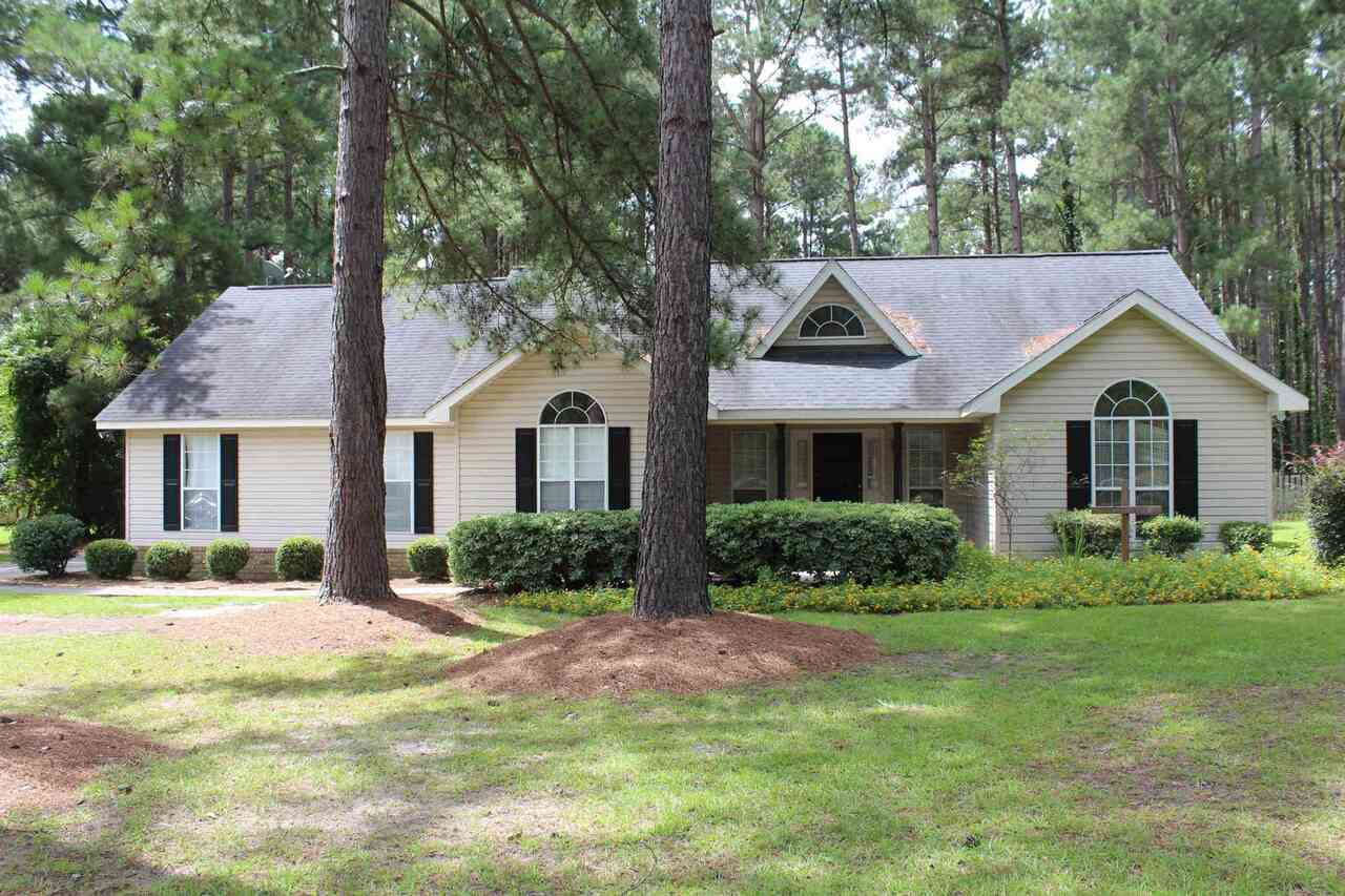 Located on a cul-de-sac street in Country Walk Plantation. Split bedroom plan with over 1700 sq. ft. Master bathroom with separate tub and shower. Large kitchen with stainless steel appliances and an eat in area that overlooks the deck. Formal dining room off the foyer and kitchen. Vaulted ceiling in the great room with a wood burning fireplace. Plank vinyl flooring in foyer, dining room, bathrooms and bedrooms. Tile in kitchen and great room, no carpet at all. Large fenced back yard with room for a garden, play set and more. Storage building remains with the property, lean to attached for extra storage space.