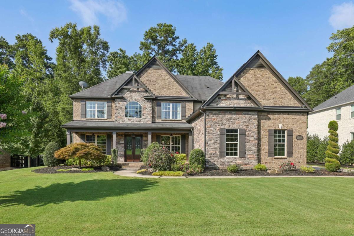 Move-In Ready and Ready for Quick Close- Ask About Our Lender Who Can Close in Just 3 Weeks! Beautifully maintained and packed with upgrades, this 4-sided brick and stone traditional is located in a quiet cul-de-sac in an active swim/tennis community just minutes from Downtown Alpharetta, Avalon, and Crabapple Market-with quick access to GA-400 for commuters. Step inside to find a light-filled, neutral palette and a spacious layout with formal living and dining rooms, a guest suite on the main, and a stunning two-story great room featuring a wall of windows, floor to ceiling stacked stone fireplace, built-in bookcases, and coffered trey ceiling. The gourmet kitchen is a chef's dream-complete with stainless steel appliances, granite countertops, an island, and a breakfast area that opens to the keeping room and great room. Upstairs, you'll find the oversized primary suite with a massive walk-in closet and spa-like bath, plus three additional bedrooms, a jack and jill bathroom and a private en-suite and a convenient laundry room. Outside, the flat, beautifully landscaped backyard is ideal for entertaining, with a covered patio featuring a fireplace and TV, a pergola, and plenty of privacy. The large, flat driveway leads to a generous 3-car garage with built-in storage that stays. Enjoy relaxing on the charming front porch with a swing for the new owners and space for rocking chairs. This home has been meticulously cared for by an owner who is immaculate and detail oriented. This home is truly move-in ready. Don't miss your opportunity-schedule a showing today and close in just 3 weeks!