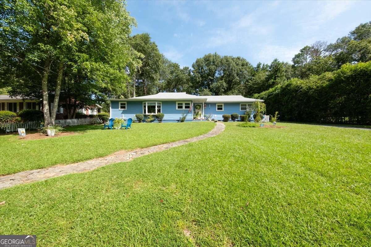 Bright & cheery 2 BD, 2 BA home in a great Forsyth location, minutes from schools, downtown & I-75. Recently renovated with new roof, gutters & new HVAC. Kitchen with island opens to cozy living area, master suite with walk in closet. Hardwood floors, ceramic tile and an abundance of windows. Carport, out building and above ground pool. Beautifully landscaped back yard. Won't last long!