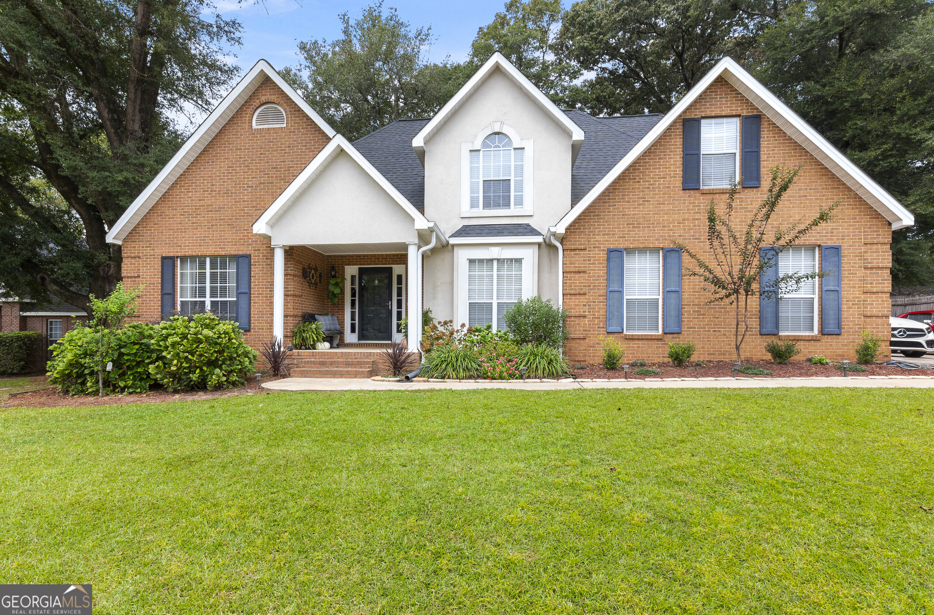 Welcome Home! This fantastic 5-bedroom, 4-bath home offers 2,581 sqft of comfortable living space on a spacious .40-acre lot, nestled in the desirable Harper's Ridge Subdivision. Step into the inviting foyer that opens into a bright living room featuring soaring ceilings, warm wood flooring, and a cozy gas fireplace. Just off the entryway, you'll find a formal dining room, perfect for hosting gatherings and special occasions. The kitchen boasts abundant white cabinetry, a breakfast area, and easy access to the spacious laundry room with built-in cabinets for extra storage. On the main floor, the primary suite includes a walk-in closet and a large en-suite bath with a double-sink vanity and soaking tub. Also on the main level is a versatile additional room with its own full bathroom - ideal for a home office, in-law suite, or man cave. Upstairs, you'll find three more bedrooms and a full bathroom, providing plenty of space for family or guests. The bonus room, featuring carpet flooring, offers flexibility for a playroom, media room, or hobby space. Enjoy the outdoors year-round in the enclosed back porch, perfect for relaxing or entertaining.
