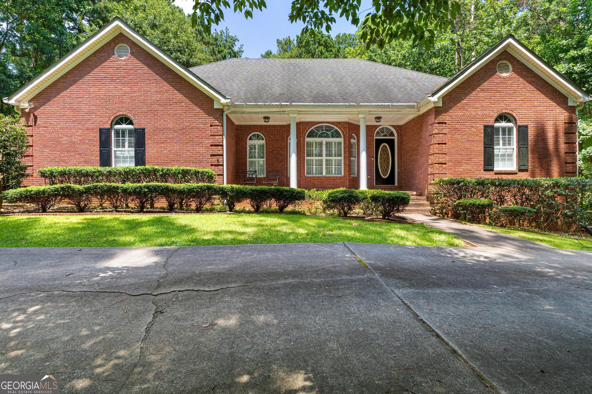 Charming Ranch on 1.15 Acres with Finished Basement, Saltwater Pool & More in Ola School District! Welcome to this beautifully maintained 4-bedroom, 3-bathroom ranch nestled on a spacious 1.15-acre lot in the sought-after Ola School District. Step inside to find gleaming hardwood floors throughout the main level, a bright and inviting living space, and a tiled kitchen perfect for entertaining. Downstairs, the fully finished basement offers incredible versatility with a large family/recreation room, a dedicated home gym, a utility room, and even a hidden panic room for added peace of mind. Enjoy Georgia's warm seasons relaxing under the covered back porch or swimming in the saltwater pool, all within a fully fenced backyard - ideal for gatherings, pets, and privacy. This home offers the perfect blend of comfort, function, and security - all within minutes of top-rated schools, shopping, and dining. Don't miss your chance to own this unique retreat in one of the area's most desirable school districts!