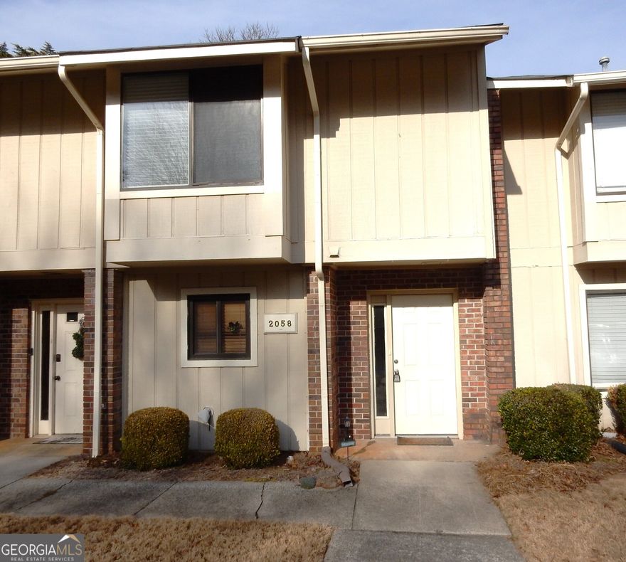 Come see this ready to move-in townhome in the well established, highly sought-after Covered Bridge Community. The convenient location is close to Atlanta with easy access to major highways, Braves stadium and the Battery, shopping and dining venues, plus nearby parks. Highly rated Marietta schools are also a major appeal. Entry foyer leads to the spacious dining room with volume ceiling. The large kitchen is open to the dining room and features stainless steel appliances with tons of counter and cabinet space plus a handy pantry. The large family room features a cozy fireplace and opens to the private enclosed rear porch and patio. Upstairs you will find two primary bedroom suites, each with their own private bathroom and ample closet space. You will enjoy this quiet tucked away  community with pool and tennis court.