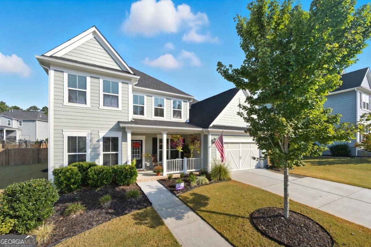 Welcome to the neighborhood - we can't wait to have you here! Nestled on one of the quietest streets in the sought-after Reunion Country Club community in Hoschton, this beautiful 4-bedroom, 3.5-bath home is the kind of place you dream of calling home. Still cherished by its original owner, it's been lovingly updated and cared for - and it shows. The main level blends open-concept living with smart, functional spaces. While the kitchen - featuring beautifully upgraded cabinetry - flows effortlessly with the breakfast nook and family room for easy entertaining, there's also a tucked-away landing area perfect for dropping bags, shoes, and daily essentials. A spacious private office with French doors gives you a quiet place to focus, and the large formal dining room sets the stage for holiday dinners and special celebrations. Upstairs, a versatile loft/flex space anchors the level, offering the perfect spot for a playroom, media area, or homework zone. The primary suite is a true retreat with his-and-hers walk-in closets, a double vanity, and a trey ceiling that adds a touch of elegance. You'll also find three additional bedrooms, two full bathrooms, and a convenient upstairs laundry room - so everyone has their own space. Thoughtful upgrades elevate everyday living - a butler's pantry dry bar with custom cabinetry and a mini fridge, a bright 10x14 sunroom, an extended back patio and fenced yard, plus updated fixtures and custom shelving throughout. Even the garage includes a bonus space for a golf cart or extra storage, making life here as convenient as it is beautiful. And as an added bonus, the seller has planted 15 Italian cypress trees that will mature into a lush living screen, providing wonderful natural beauty and extra privacy over time. Living in Reunion means more than just a gorgeous home - it's about joining a vibrant, welcoming community with resort-style amenities: a championship golf course, swimming pools, tennis courts, clubhouse, parks, and a full calendar of neighborhood events. It's the kind of place where neighbors wave, kids play freely, and lifelong friendships are made. This is more than a house - it's your next chapter. And we can't wait to welcome you home.