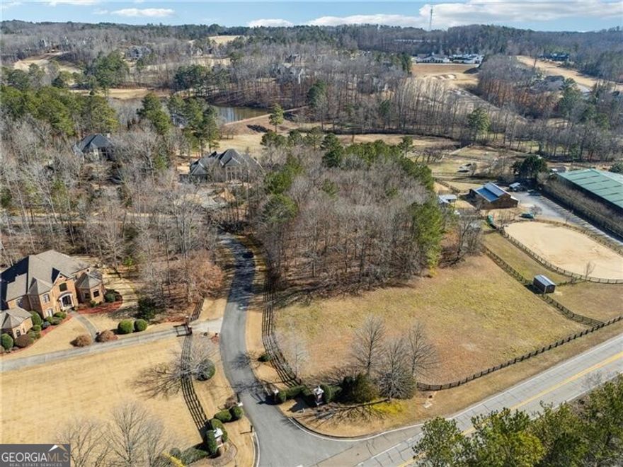 3-acre homesite located in The Paddocks of Alpharetta, an exclusive five-home enclave, offers a rare opportunity to build your dream estate in a highly desirable location. This flat, partially cleared, and partially wooded lot provides the perfect balance of open space and natural privacy. With the advantage of Cherokee County taxes and zoning for Creekview High School, this property combines desirable tax benefits with top-rated schools.  Just five minutes from 7 Acre BarnGrill, Publix, and Scottsdale Farms, this homesite is ideally positioned for both convenience and lifestyle. Golf enthusiasts will appreciate the close proximity to The Manor Golf & Country Club, Hawks Ridge Golf Club, and Echelon Golf Club, while equestrian lovers will enjoy being in the heart of North Georgia's horse country, surrounded by scenic horse farms. A short drive leads to Downtown Crabapple in Milton, Downtown Alpharetta, and Avalon, where high-end shopping, dining, and entertainment await. This exceptional property provides the perfect balance of tranquility and accessibility.