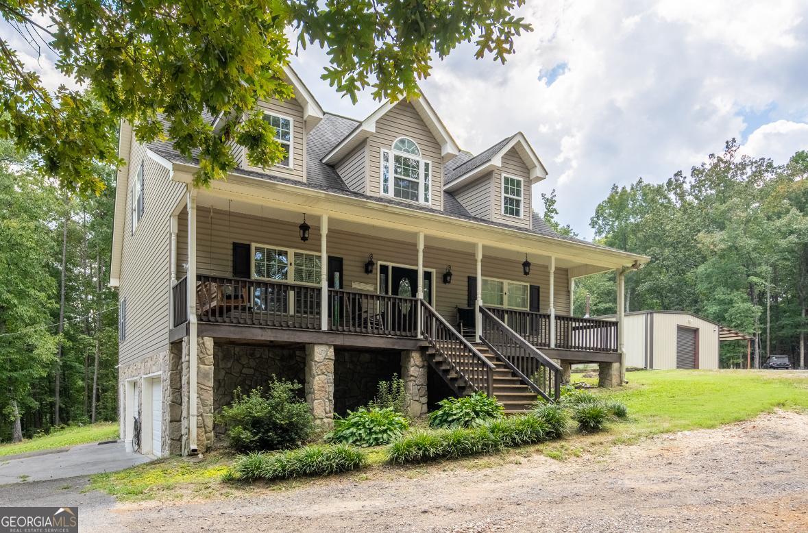 Priced at appraised value! This one-owner home offers ultimate privacy and peaceful seclusion. When asked what she loved most, the seller said, "I love my outdoor living space and not seeing a single neighbor!" Her husband added, "I'll miss my shop the most." Tucked away from the road, you're welcomed by a full-length front porch and an even larger back porch-perfect for relaxing or entertaining. Step inside to a cozy living room that opens to the dining and kitchen areas. The oversized main-level master bedroom offers endless layout possibilities-bring your Pinterest dreams to life! Upstairs, you'll find two generously sized bedrooms, a full bath, and abundant storage space throughout. The finished basement features a large bonus room with its own full bath-ideal as a guest suite, man cave, or recreation space. Outside, enjoy wooded surroundings and your very own detached shop, complete with an office and bathroom. A rare find with room to spread out-don't miss this private retreat!