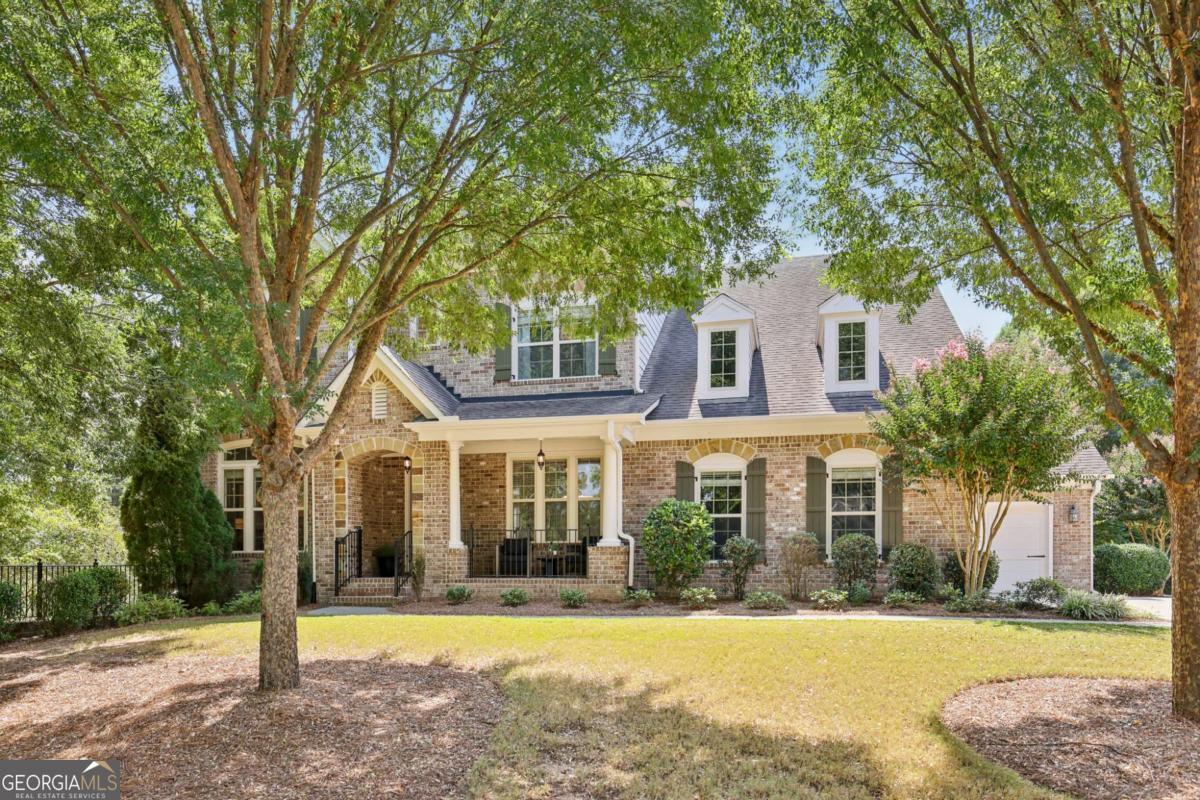 Elegant 3-Sides Brick Residence in Sought-After Alpharetta/Crabapple. Move-in ready and available for immediate close, this exceptional home combines timeless architecture with refined interiors and a coveted location. Nestled on a pedestrian-friendly street with sidewalks leading to both Downtown Alpharetta and Downtown Crabapple, residents enjoy the best of walkable living with vibrant dining, shopping, and cultural destinations just moments away. The neighborhood itself is anchored by a beautifully landscaped green space-an inviting place to gather, relax, and play. Step inside to soaring 10-foot ceilings on the main level, 9-foot ceilings upstairs, wide-plank hardwood flooring, and exquisite detailing throughout. The main level is designed for both grand entertaining and everyday comfort, featuring a guest suite, private office, gracious dining room, and a chef's kitchen with double ovens, an oversized island with clean surface design, and a seamless flow into the fireside great room adorned with elegant coffered ceilings. A well-planned mudroom/drop zone adds practical luxury. Enjoy indoor-outdoor living with an expansive deck that commands views across the meticulously maintained lawn and private backyard-an ideal setting for alfresco dining or serene evenings at home. Upstairs, the primary suite is a true retreat with a generous sitting room, boutique-style walk-in closet, and spa-inspired bath. Three additional spacious bedrooms offer exceptional closet space, with two sharing a Jack-and-Jill bath and one featuring a private en-suite. A full daylight terrace level, already stubbed for a bath, provides endless opportunity for customization-whether you envision a sophisticated recreation lounge, a private guest retreat, fitness studio, or home theater. Additional appointments include a 3-car side-entry garage, welcoming front porch perfect for morning coffee or evening relaxation, and an unparalleled location within minutes of top-rated schools and the heart of Alpharetta.