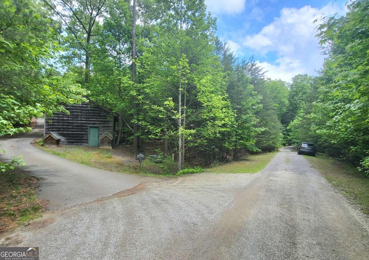 Here's an affordable 1.31 acre building lot with underground utilities in Folklore Mountain, a small desirable mountain community of just 19 lots, most of which have already been developed or purchased by adjacent property owners. Lot 9 is located just 11 miles from shopping in Blue Ridge, or to the Marina at Lake Blue Ridge. And it's just 15 miles to Blairsville or to the Cozy Cove Marina on Lake Nottely. The gentle sloping wooded , lot borders a small spring-fed creek, with seasonal mountain views depending upon the placement of the home on the lot. THERE ARE NO DANGEROUS STEEP ROADS. There are lovely cabins in Folklore Mountain, in fact, the beautiful custom cabin at 477 Bootlegger Rd is currently for sale MLS #415869.