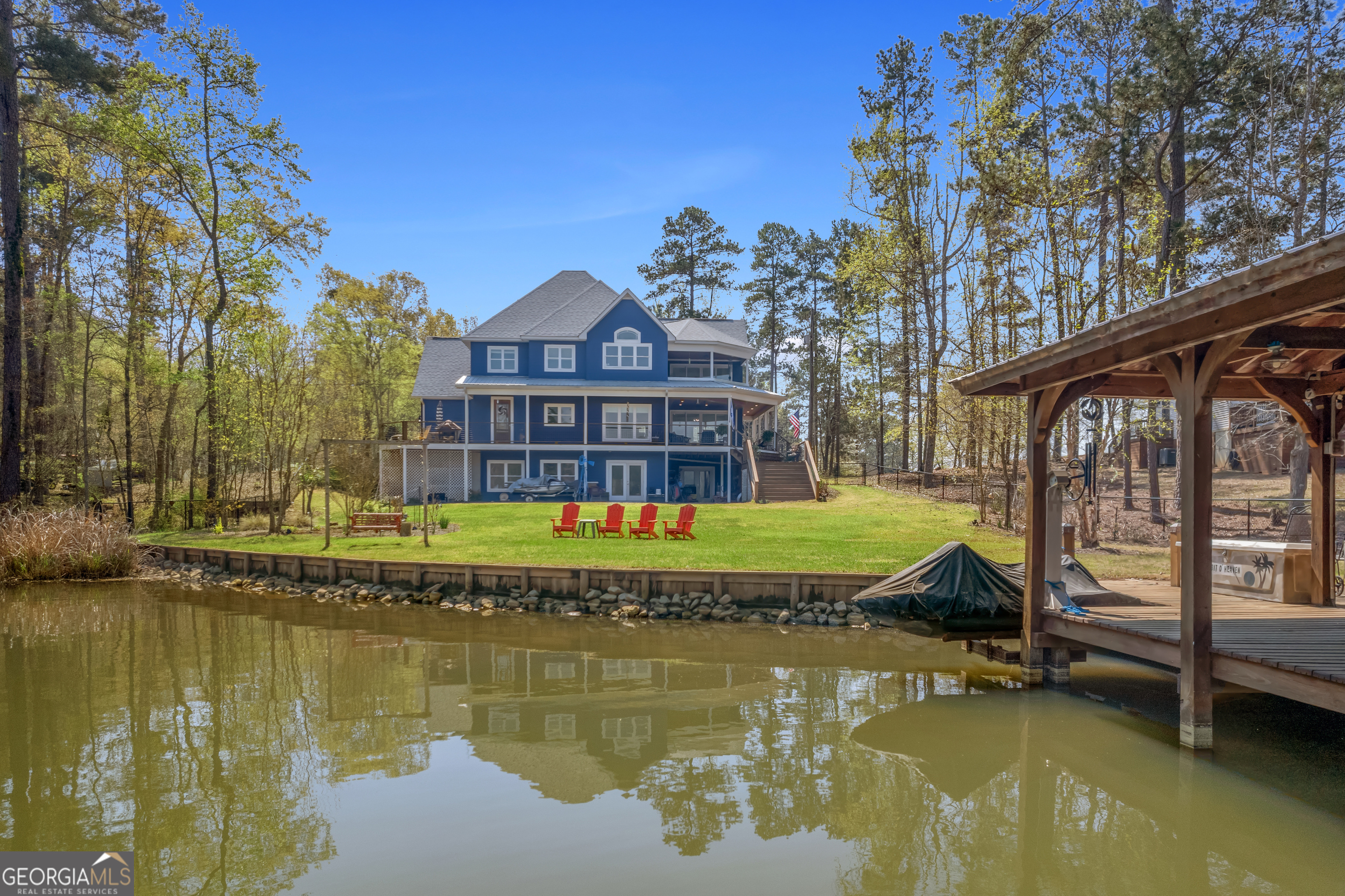Breathtaking Lake Sinclair Custom Home | 120' Waterfront | Stunning Lake Views Welcome to your dream lakefront retreat! This custom-built 3-bedroom, 2 full and 2 half-bath home offers panoramic Lake Sinclair views from every room. Nestled on 120 feet of pristine water frontage, this property is a rare gem designed for comfort, style, and unforgettable lake living. Step inside to a gourmet kitchen featuring a professional-grade Thor gas stove, perfect for creating meals to enjoy with friends and family. The open-concept layout leads seamlessly to the living and dining areas, all bathed in natural light and showcasing breathtaking water views . The living room features a coffee bar - ideal for entertaining or quiet mornings by the lake. The luxurious master suite is your personal oasis with a private balcony overlooking the lake,and a second coffee bar to begin your morning! There is a luxurous en-suite spa-inspired bath complete with a soaking tub and large walk in shower. Two additional spacious bedrooms ensure plenty of room for guests. Enjoy the convenience of a central vacuum system, a whole-house generator for peace of mind during stormy nights, and ample storage throughout. Outdoor living shines here with multiple spaces to soak in the views, including a lakeside patio, fenced yard, and a private dock with 5 feet of water depth - perfect for boating, swimming, and fishing. This is more than just a house - it's a lifestyle. Whether you're enjoying morning coffee on the balcony, hosting summer gatherings on the patio, or curling up during a storm with the generator humming softly, this home has it all. Lake Sinclair | Custom-Built | Coffee Bars | Thor Stove | Generator | 5' Water at Dock