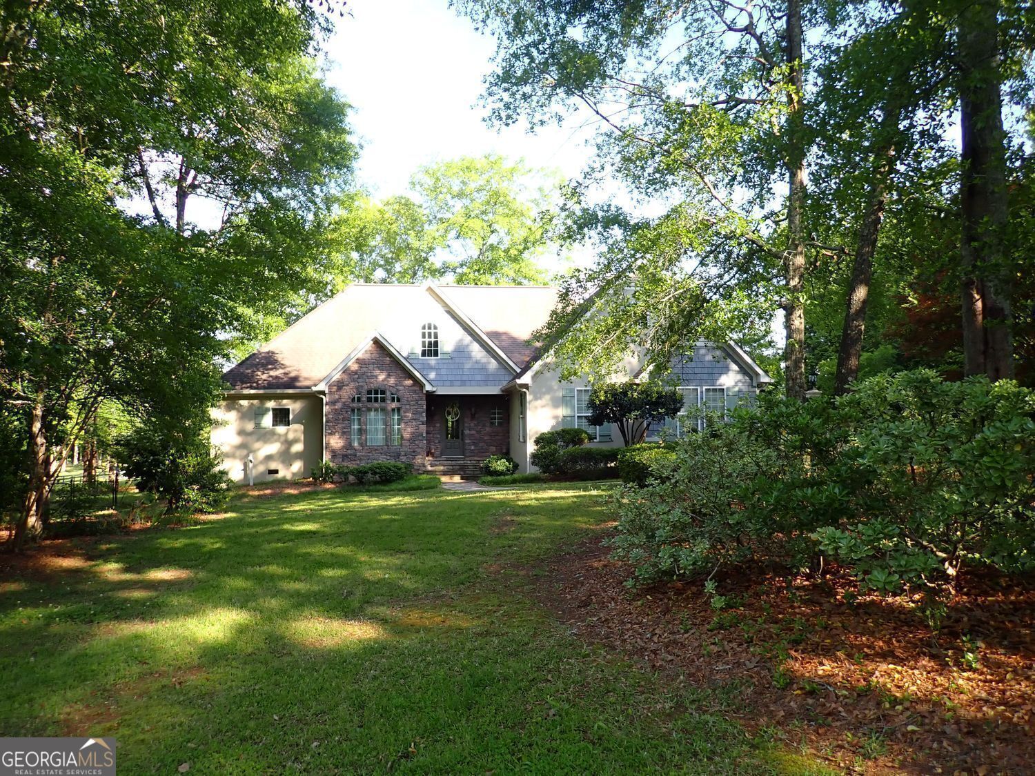 Custom built house by builder for himself/ "So" Well Built. Stucco w/ stone accents ranch with extra large bedroom room up/ Side entry 2 garage and an additional separate lg 1 car garage/ Lovely kitchen with granite countertops & stainless steel appliances/ Georgous Real Hardwood Flrs/ FDR or lovely sunlit home office/ LR/ Generous breakfast area nestled in bay windows/ mstr with huge walk in closet & mstr bath, tile,w/ sep jetted tub & shower/ secondary bed w/ spacious private bath/ huge bedroom upstairs can be 3rd bedroom or additional office/ tons of attic storage space/ attic can be expandable/ nice large rear screened porch/ shaded fenced back yd/ tons of storage in the secondary garage also/ a short bike ride to Gordon College or downtown Barnesville/ 2 HVAC and tandem water heater.
