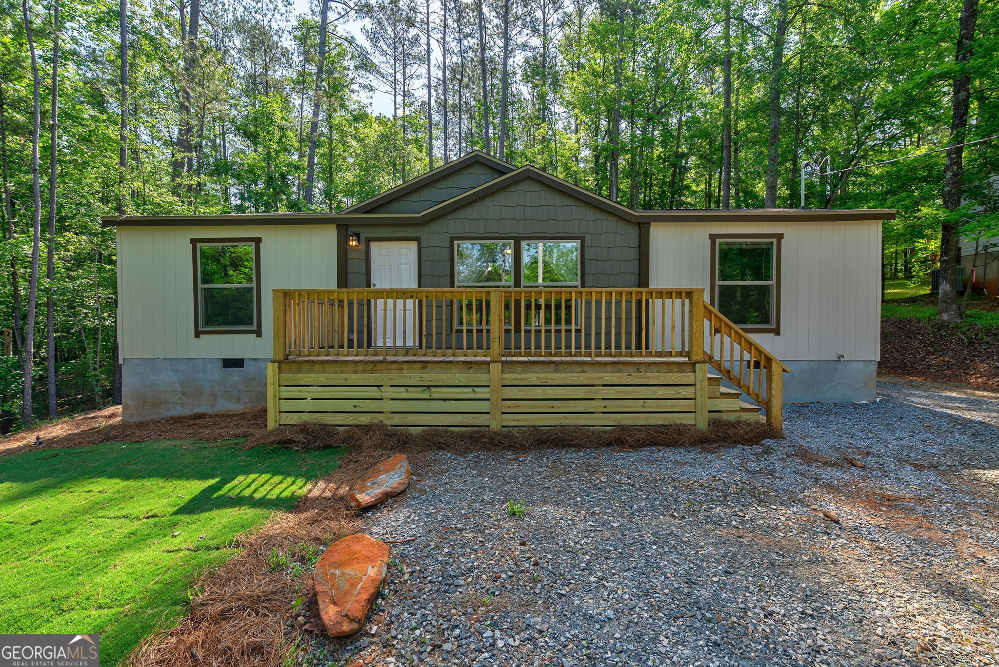 Seller is offering 10K in sellers concessions with acceptable offer. Ever dreamed of living near the lake? Well, welcome to your future home - a brand new 2025 mobile home with easy community lake access to beautiful Lake Sinclair! Sitting on just over half an acre, this cozy home is designed with comfort and convenience in mind. The split floor plan offers 3 bedrooms and 2 bathrooms, giving everyone their own space. The bright, open living room flows right into the eat-in kitchen, making it the perfect spot for family gatherings or catching up with friends over coffee. The master suite is your own private retreat, complete with a spacious walk-in closet and an ensuite bathroom featuring a relaxing garden tub and a separate shower. On the other side of the home, you'll find two more bedrooms-ideal for kids, guests, or even a home office. After a long day, imagine unwinding on the back deck, soaking in the peaceful surroundings. And when you're ready for some fun on the water, just cross the street to enjoy the community's private lake access, complete with a dock, boat ramp, and parking. This home has been FHA and VA-approved. Make sure to ask about our FHA Loan zero down at closing program with our down payment assistance program. Don't miss the chance to make this Lake Sinclair home yours!